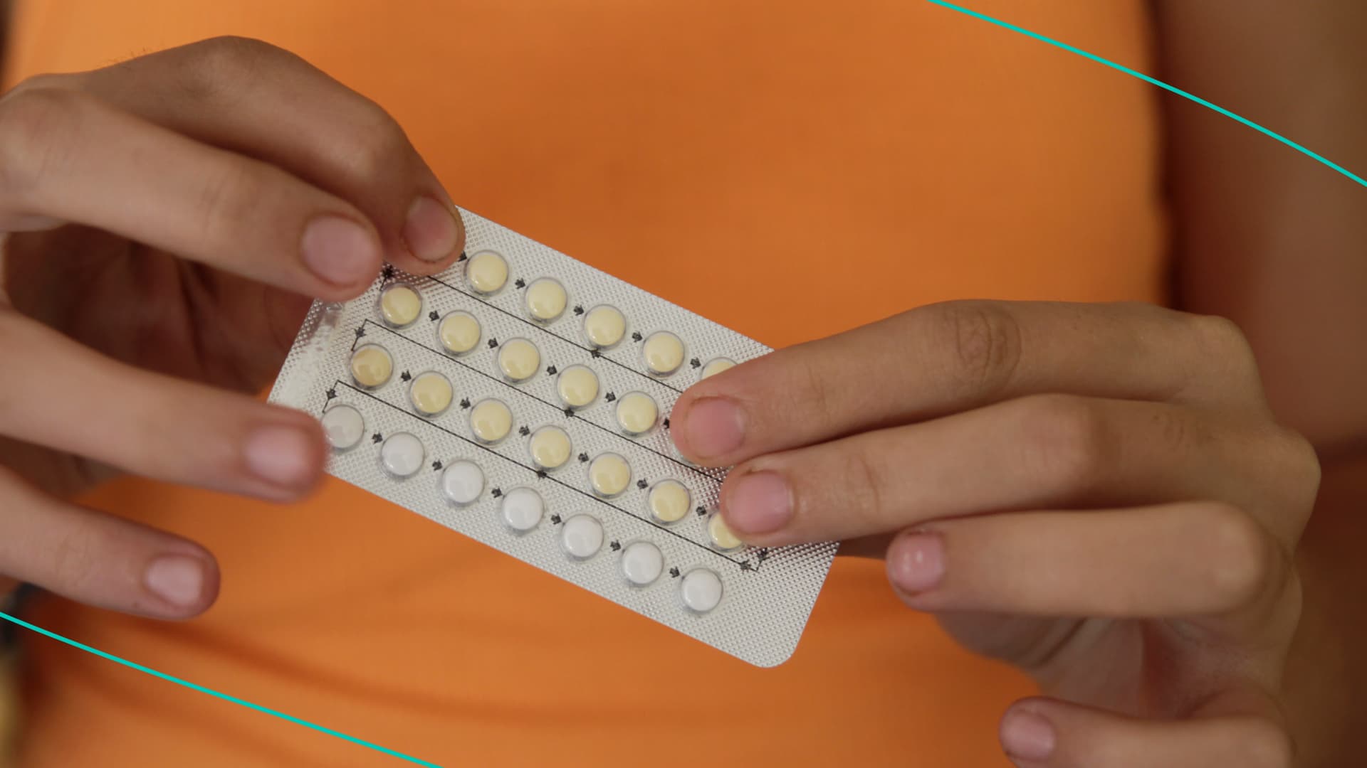 Woman's hands holding birth control pills