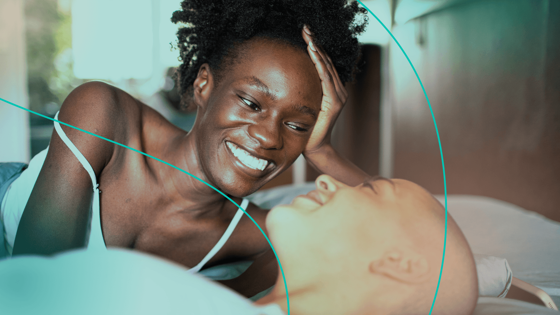 Couple looking at each other in bed