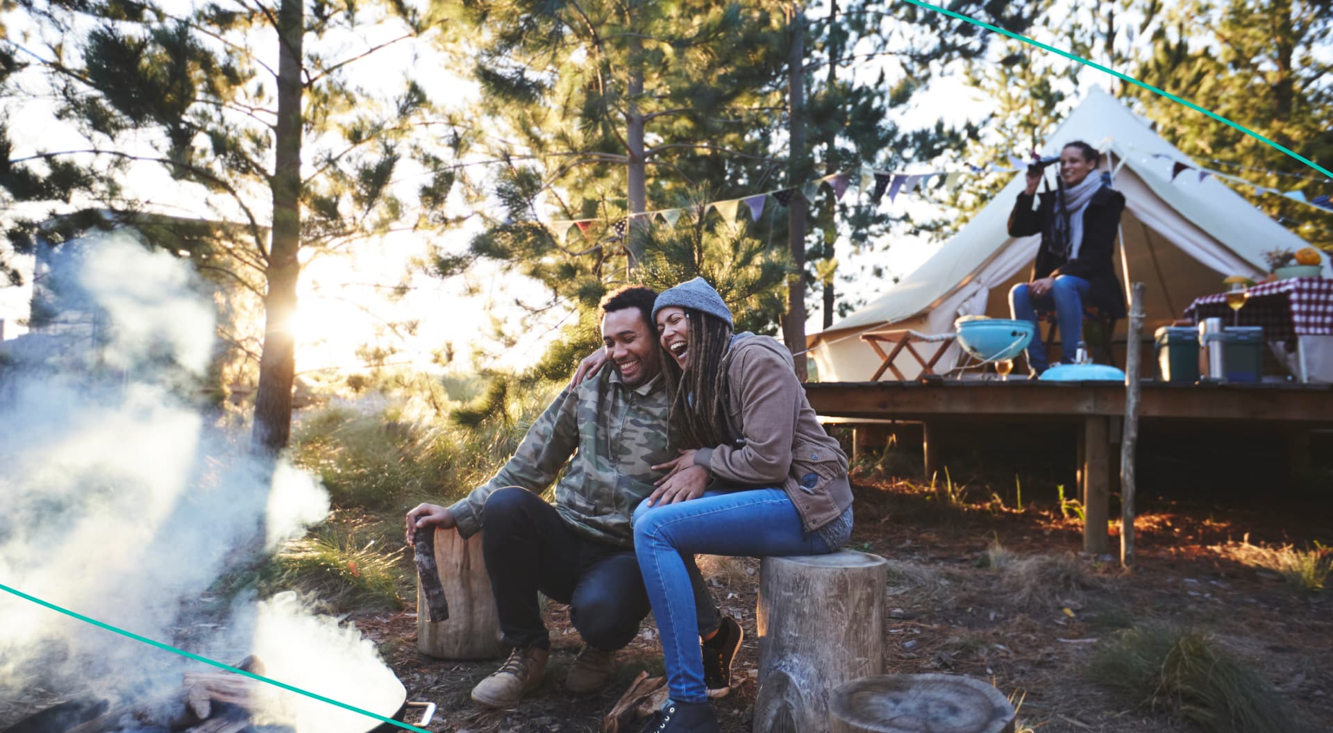 People sitting at a campsite and laughing