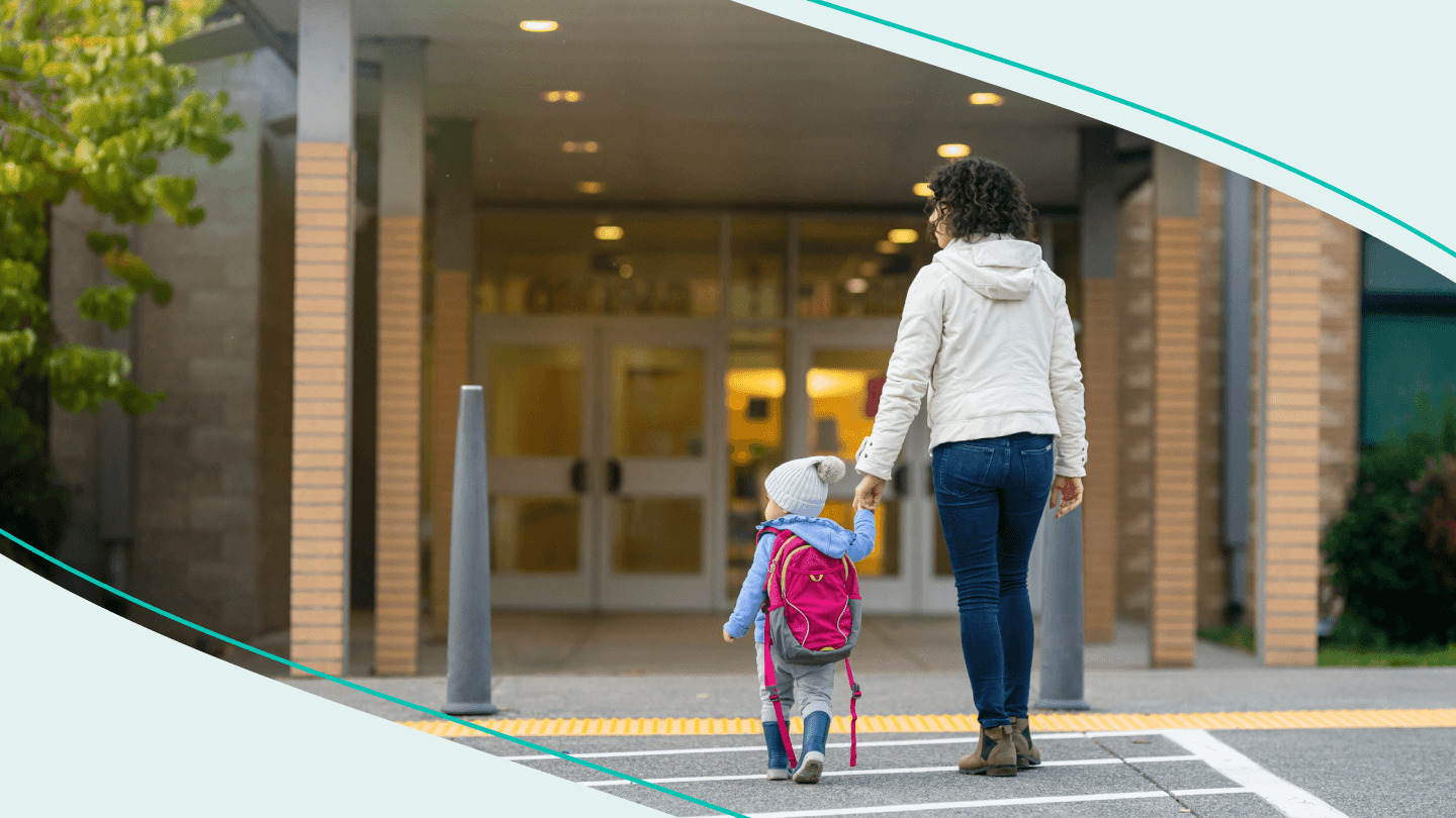 mom walking young child into school