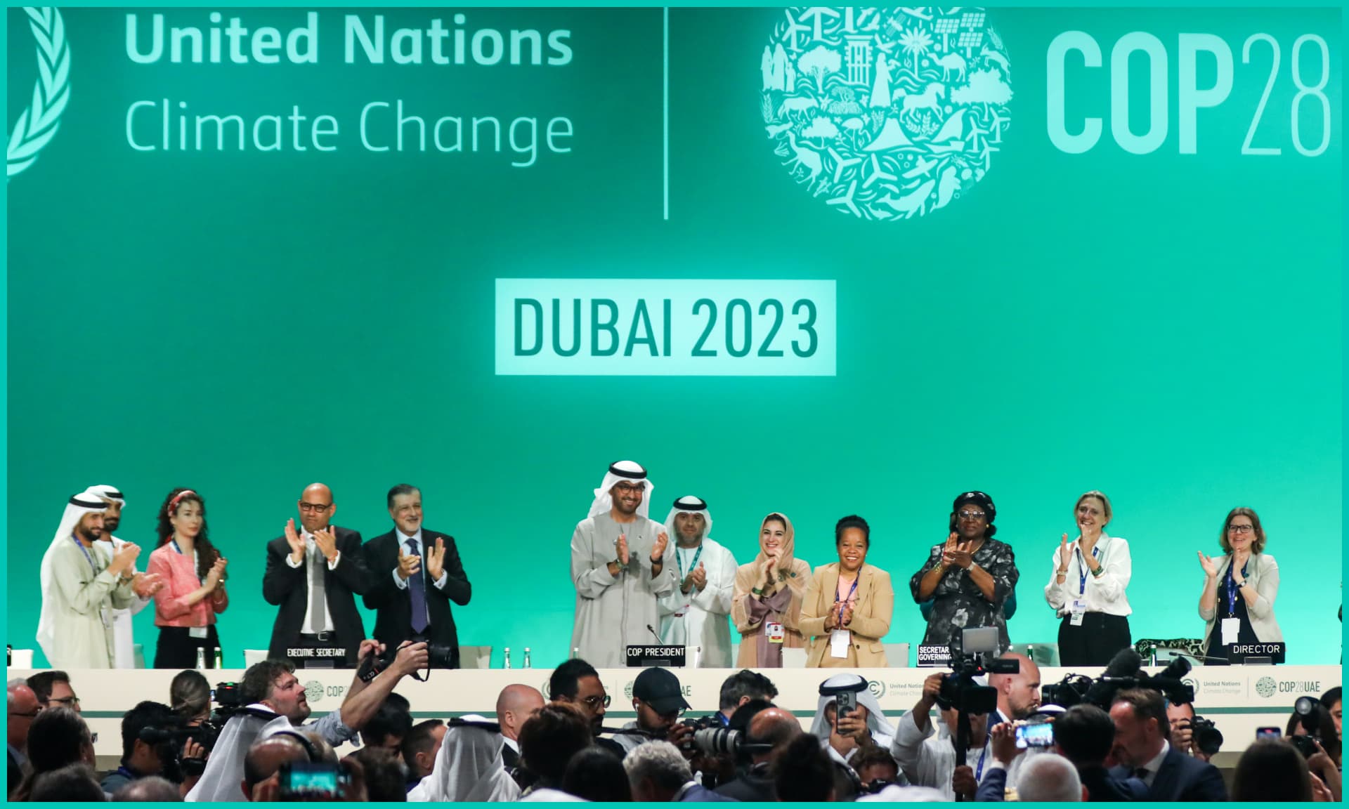 Delegates applaud after a speech by Sultan Ahmed Al Jaber (C), President of the UNFCCC COP28 Climate Conference,