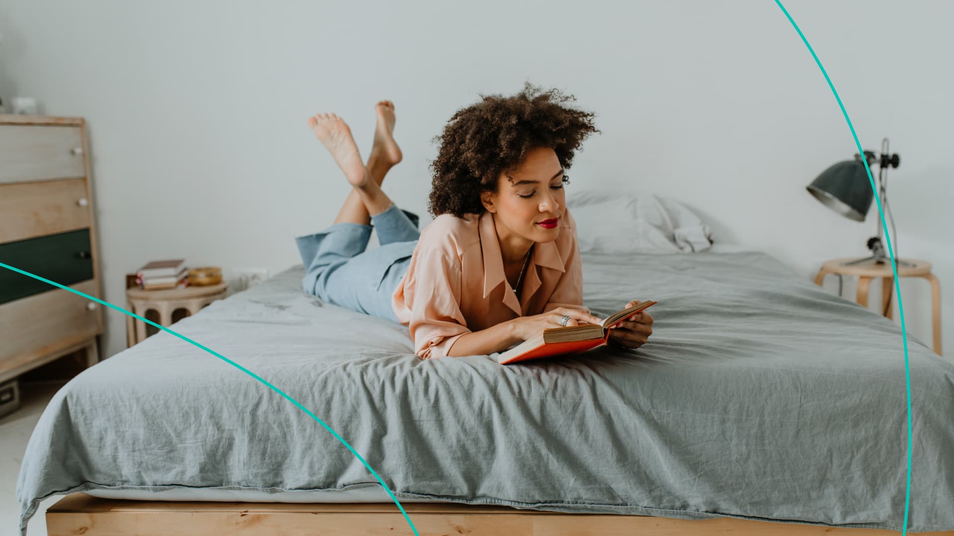 A woman reads a book on her bed