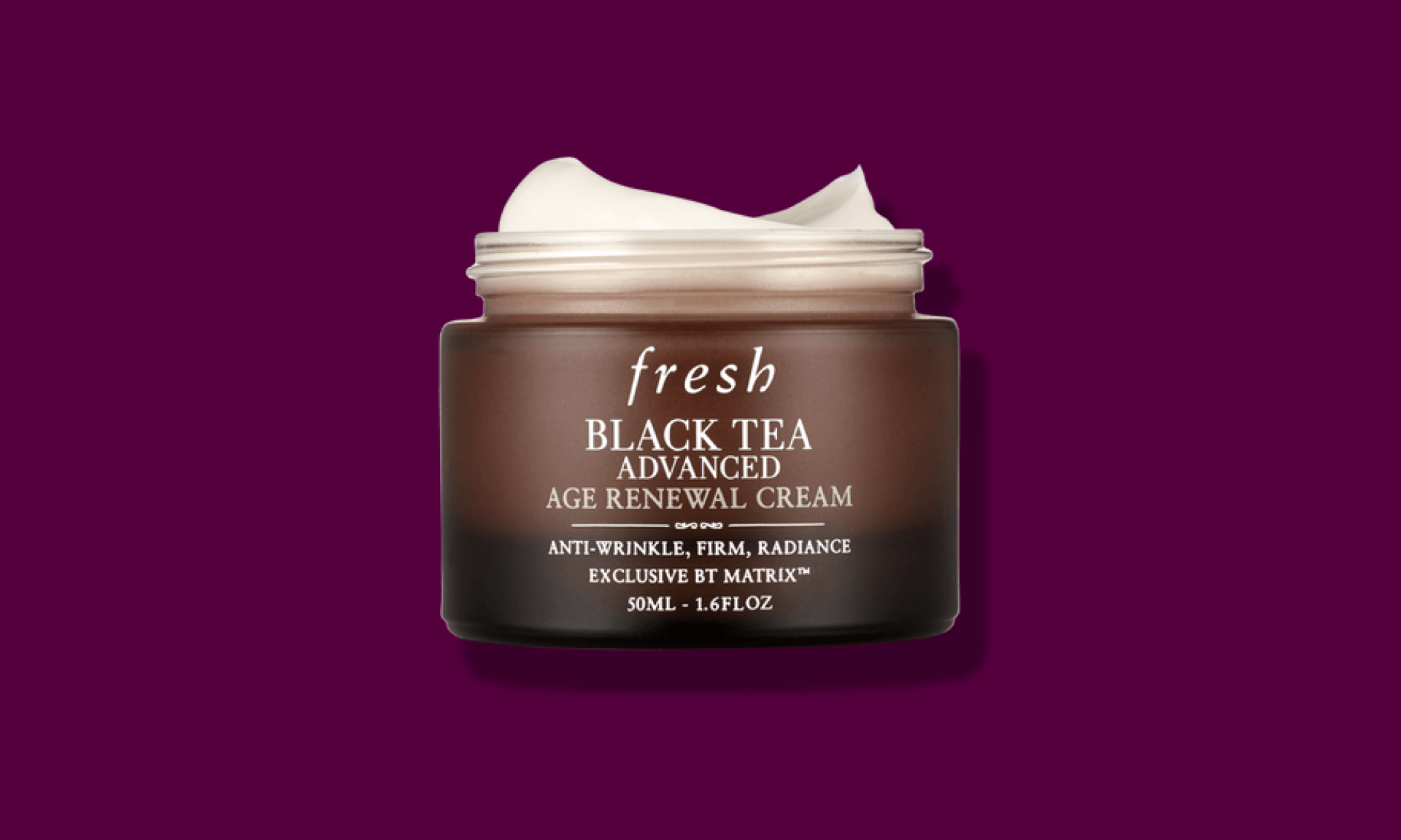 Opaque brown jar of face cream on dark purple background