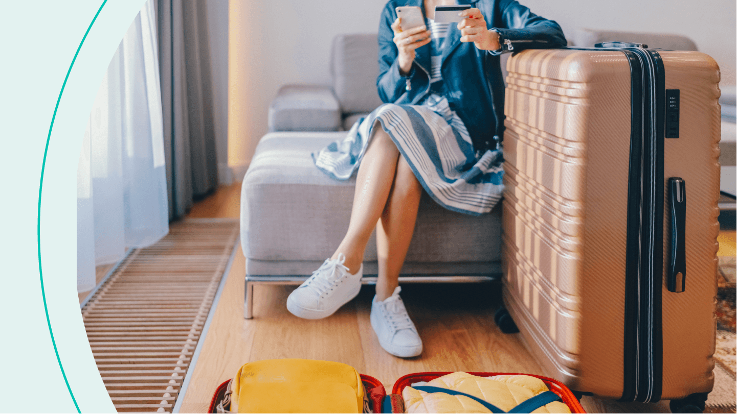 woman with big suitcase looking at phone