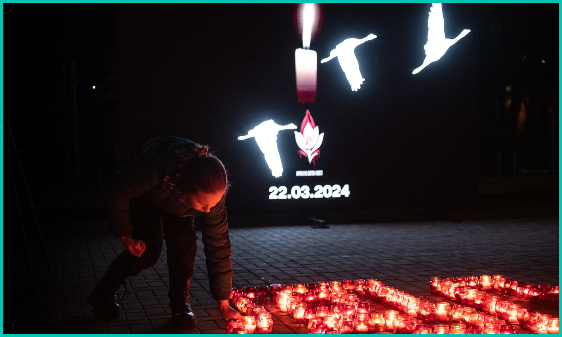 People light candles during a memorial gathering in Donetsk, Russian-controlled Ukraine, on March 24, 2024, as Russia observes a national day of mourning after a Moscow concert hall massacre that killed more than 130 people