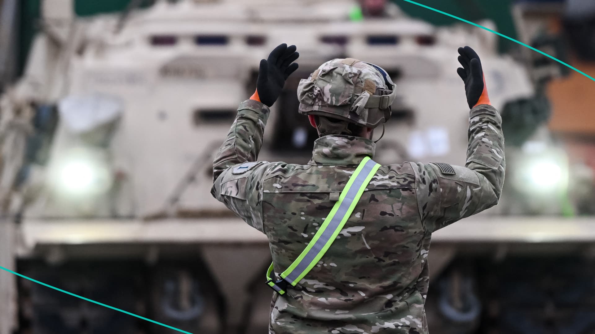 A soldier signals the way to a M1A2 Abrams battle tank of the US army that will be used for military exercises by the 2nd Armored Brigade Combat Team, at the Baltic Container Terminal in Gdynia on December 3, 2022