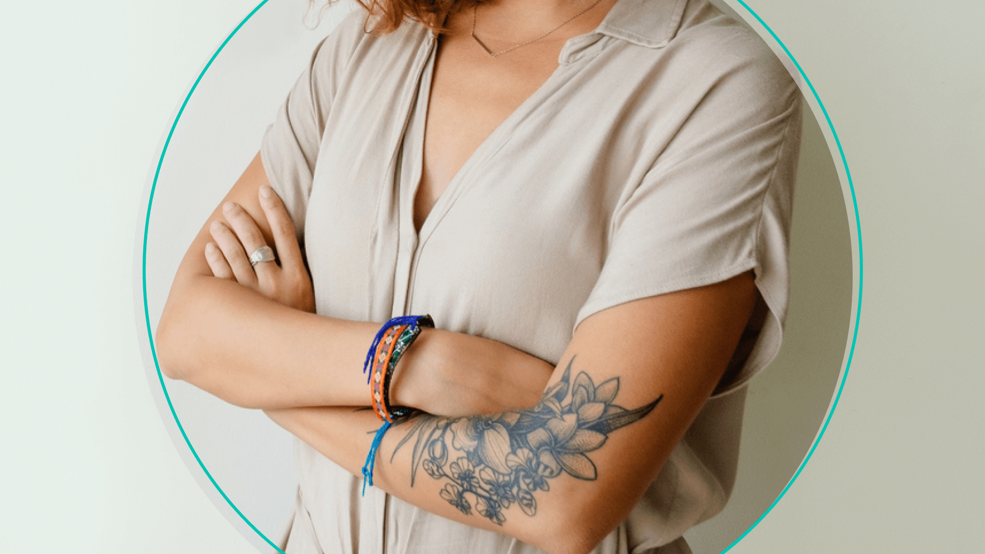 Person With Tattoo Crosses Arms