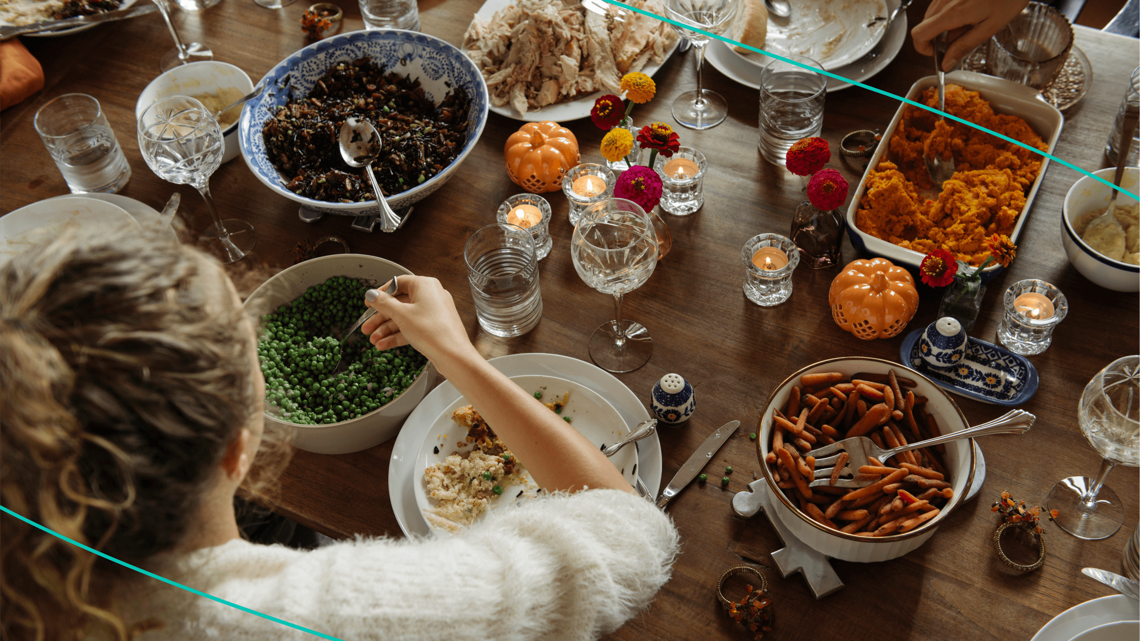 Women sitting at Thanksgiving table with variety of classic dishes