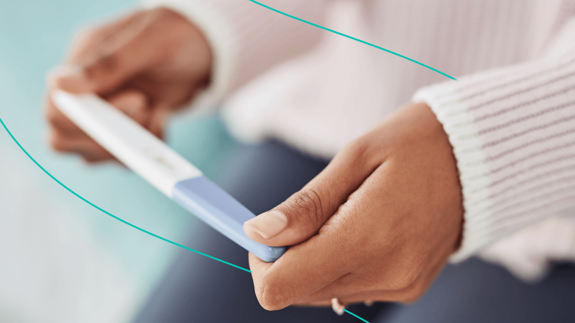 Woman holds up a pregnancy test