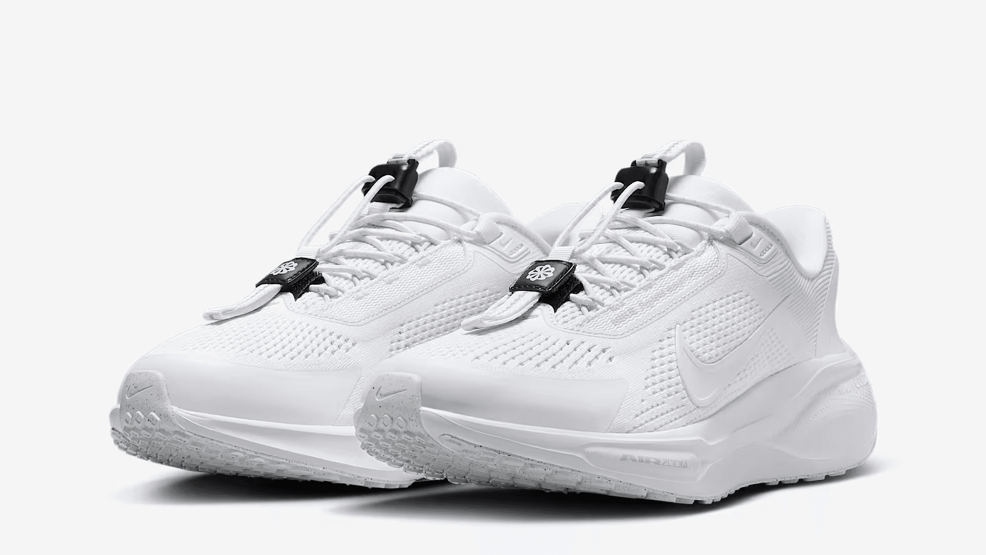 White sneakers with black adjustable pull tabs