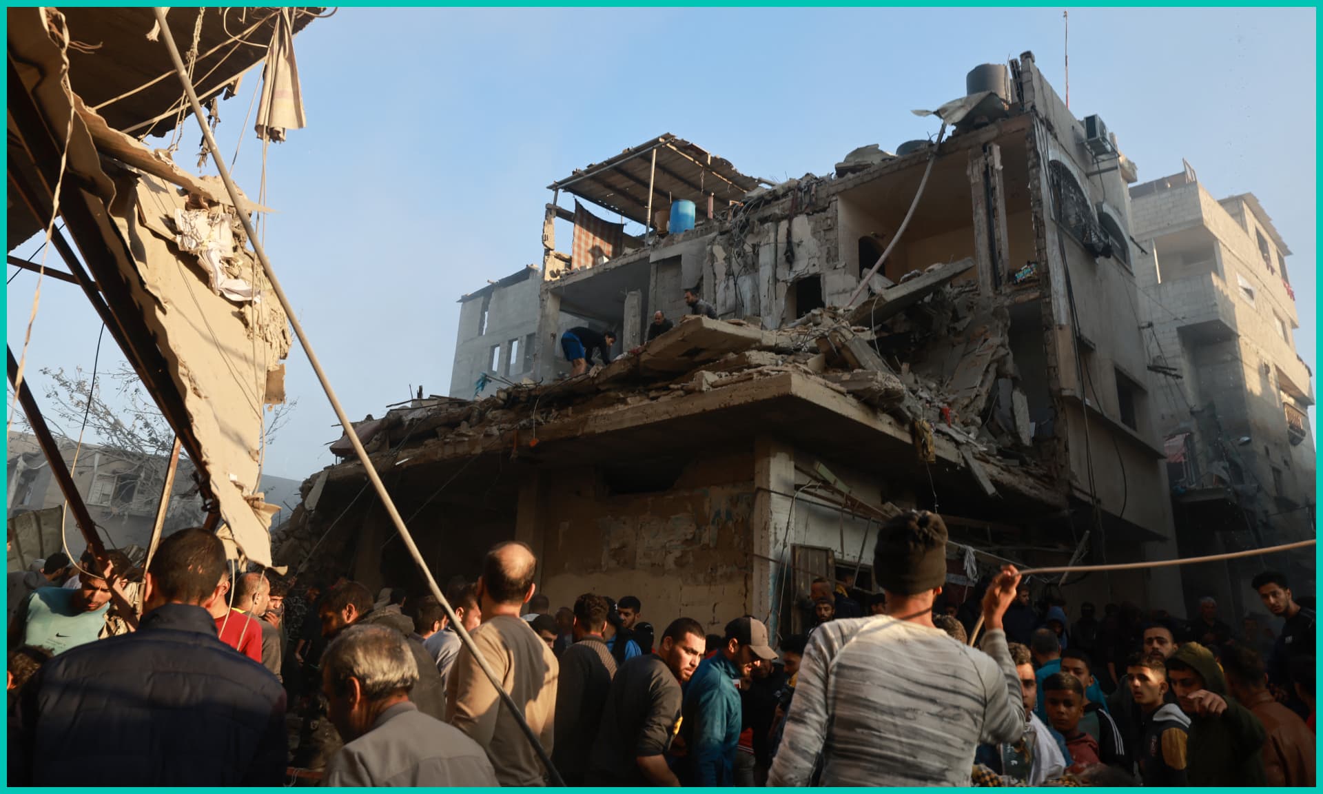 Palestinians check the rubble of a building destroyed in an Israeli air strikes on the Rafah refugee camp in the southern Gaza Strip on December 1, 2023