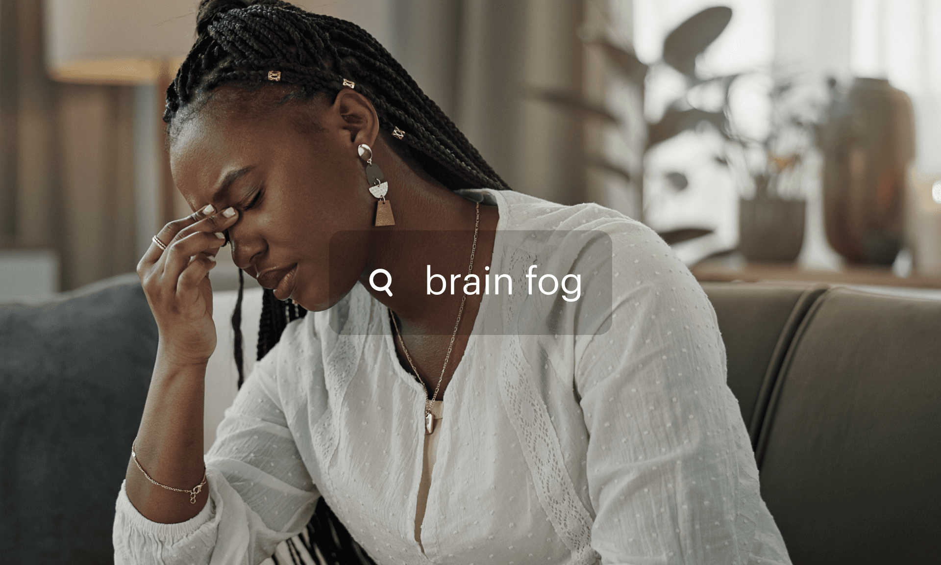 Woman holding her head behind a search bar with brain fog in it