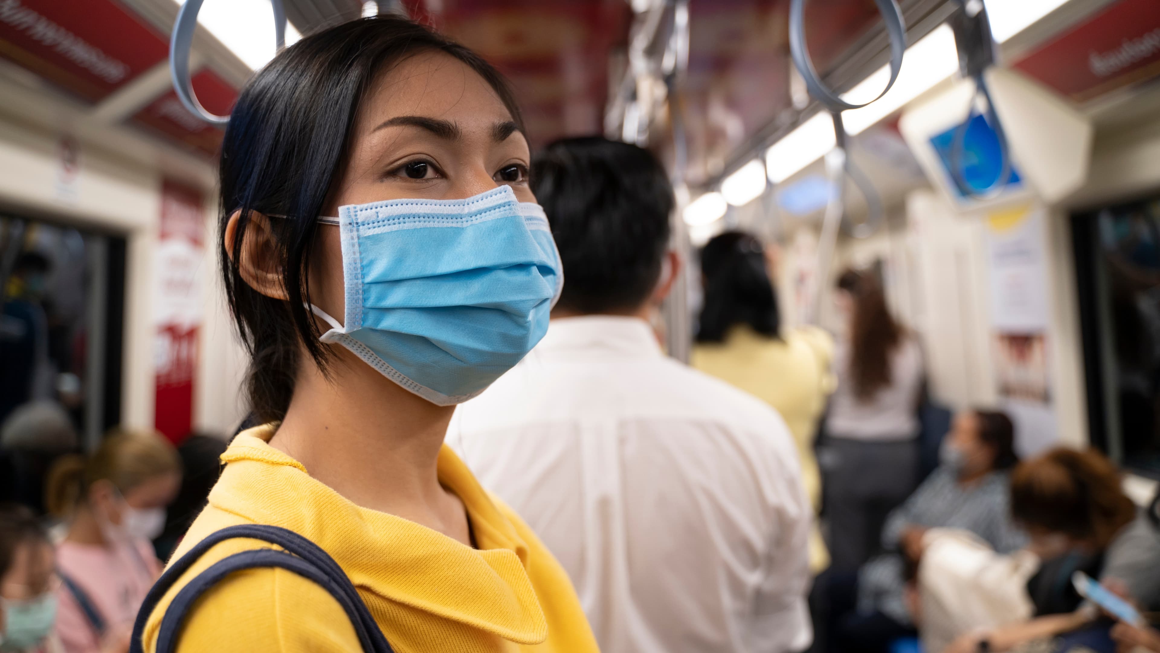 Woman on train wearing mask