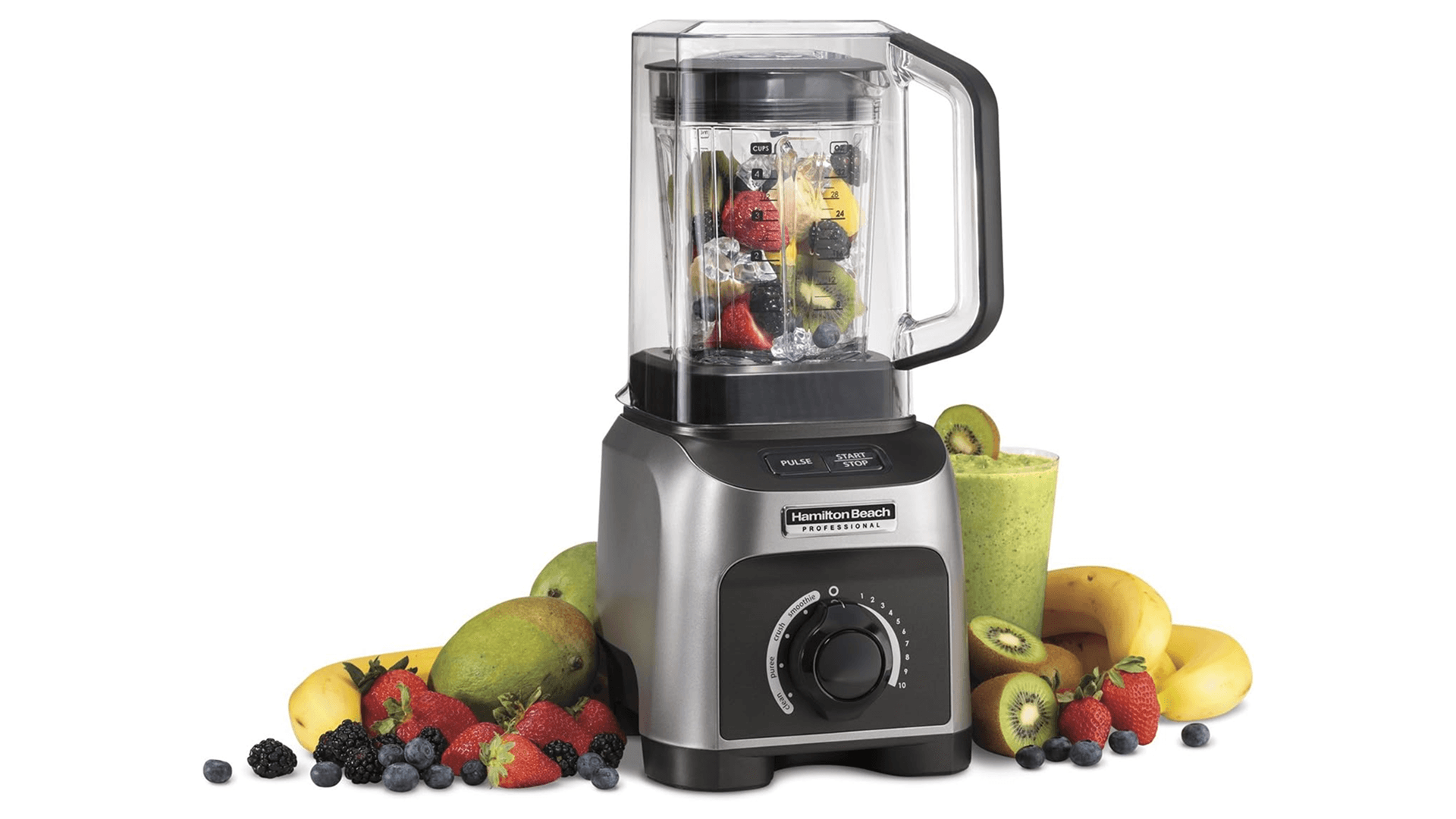 Stainless steel blender with fruit inside and fruit and blended smoothie in background