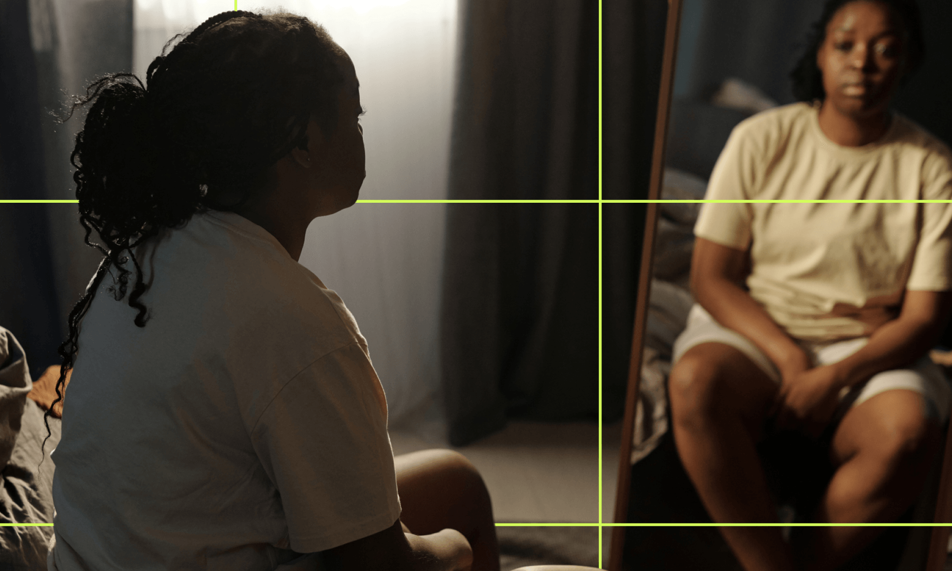 A Black woman lying on a hospital bed under an x-ray machine