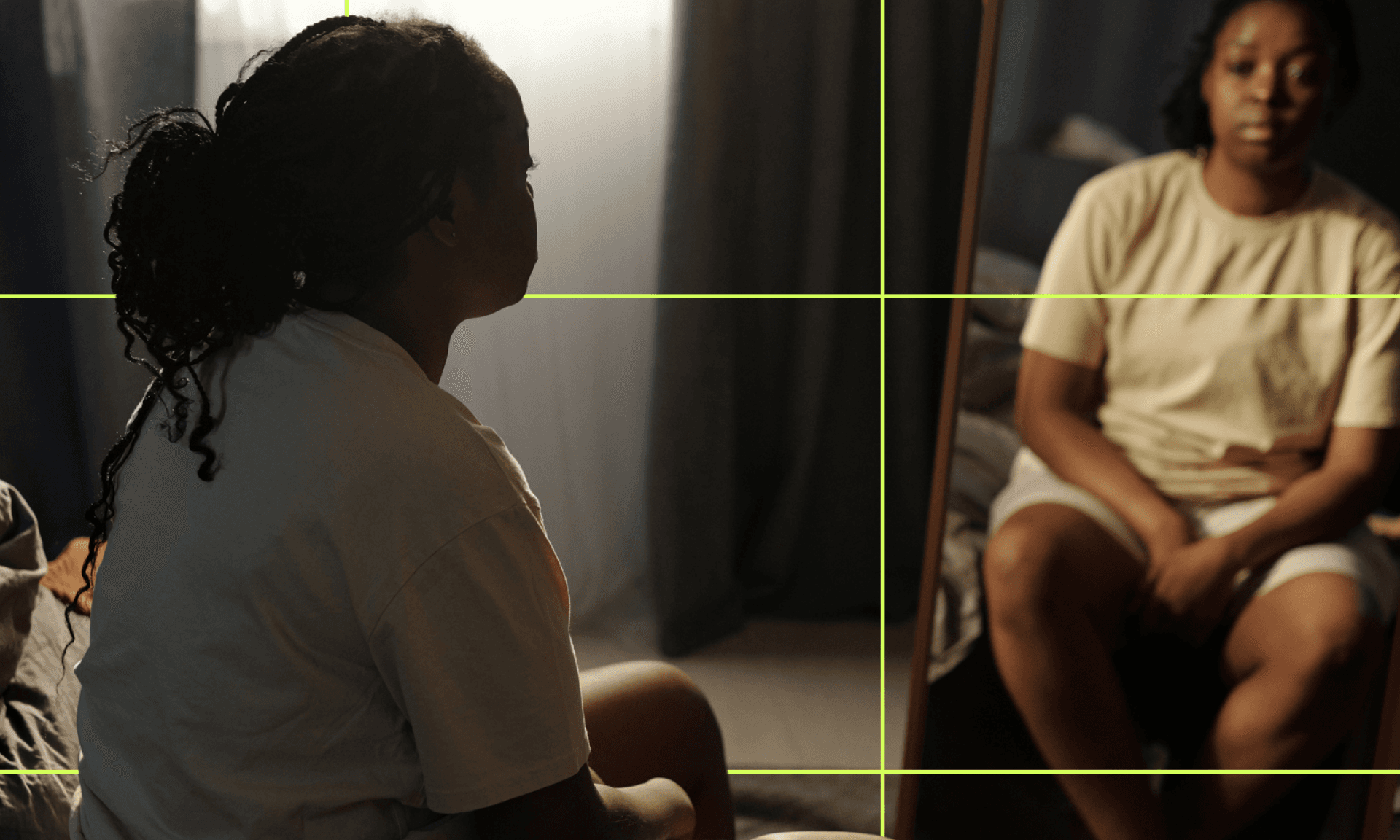 A Black woman lying on a hospital bed under an x-ray machine