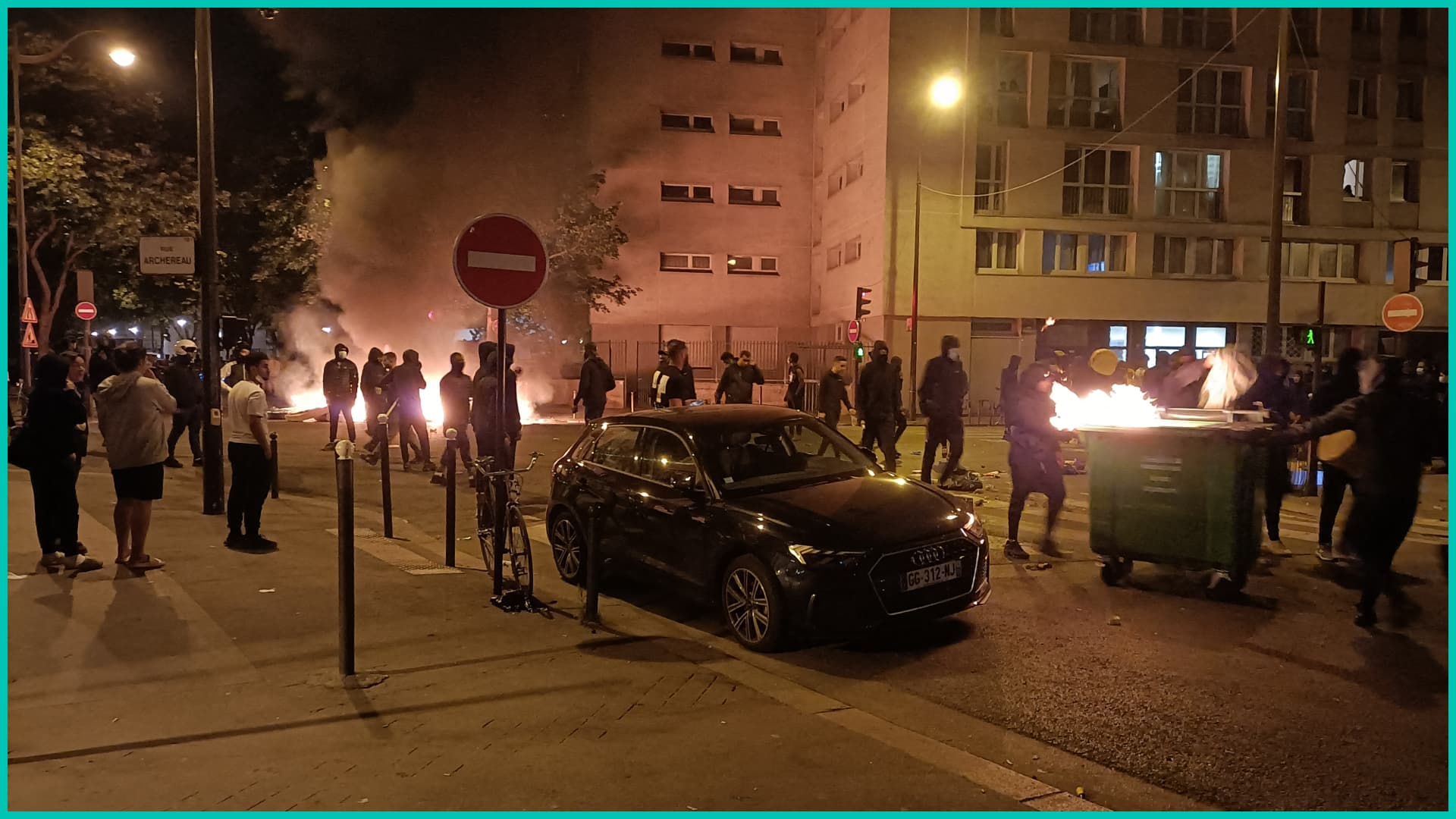 People burn rubish bins and block a street during a protest in Paris on June 29, 2023,