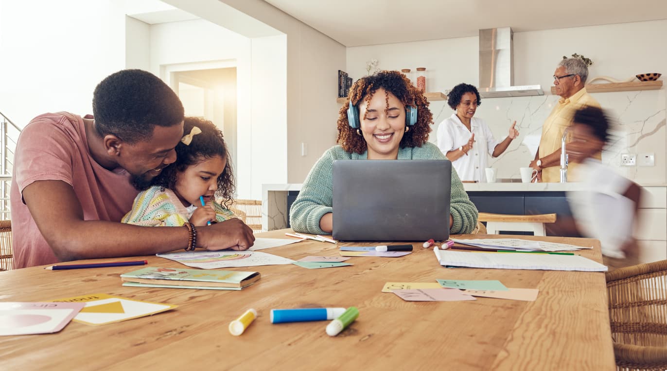 Woman at computer with family around her