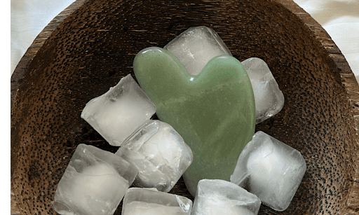 gua sha in bowl of ice cubes