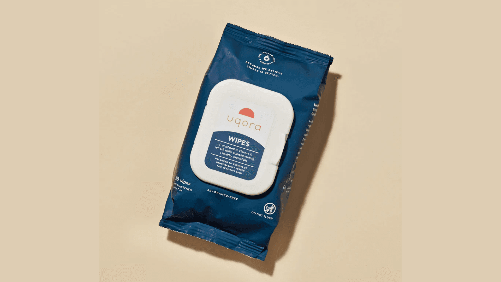 Dark blue package of wipes on pale orange background