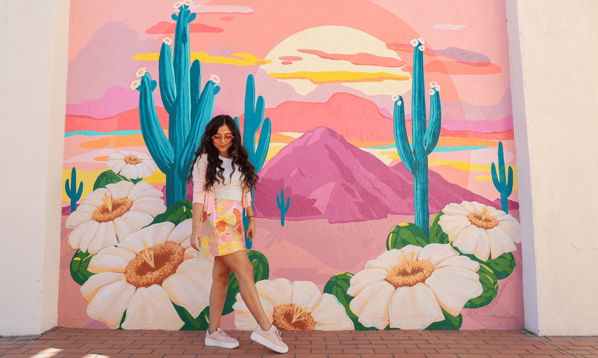 Woman in front of mural