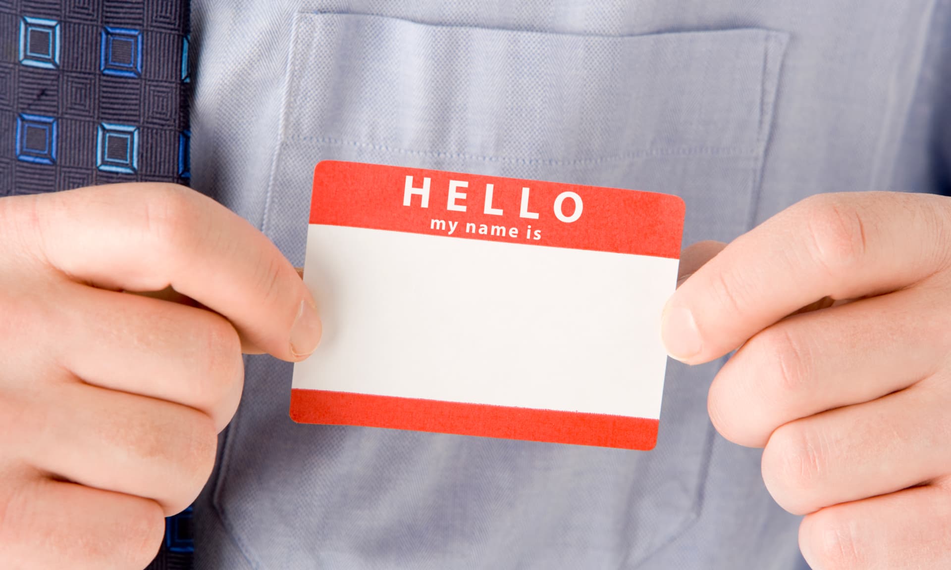 Man holding a name tag
