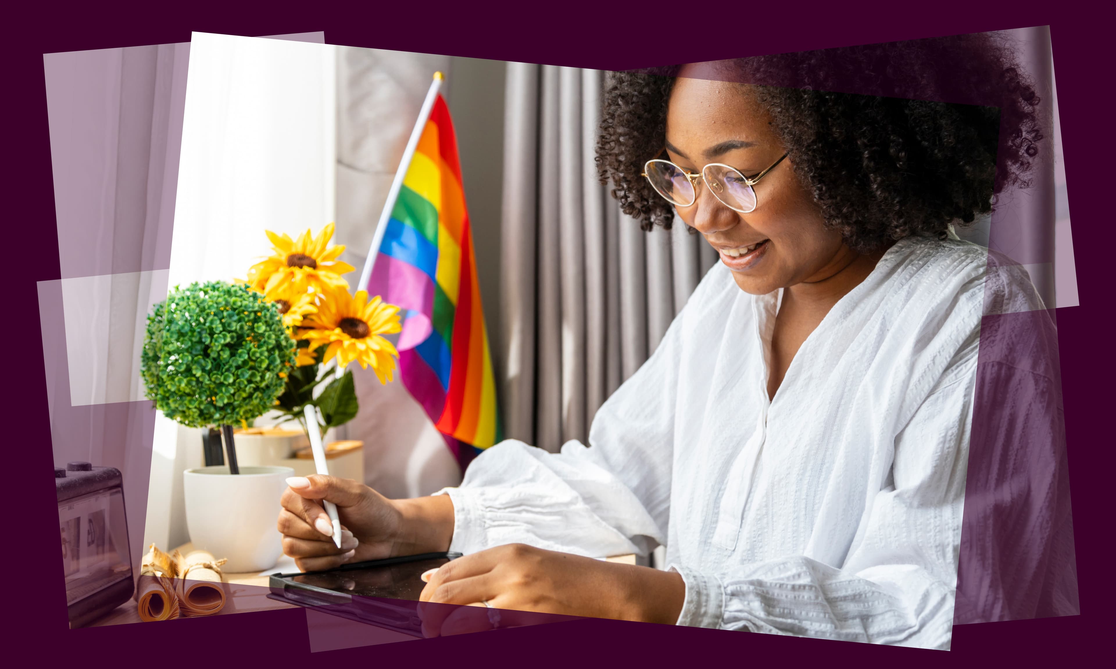 stock image of woman with tablet and pride flag in background