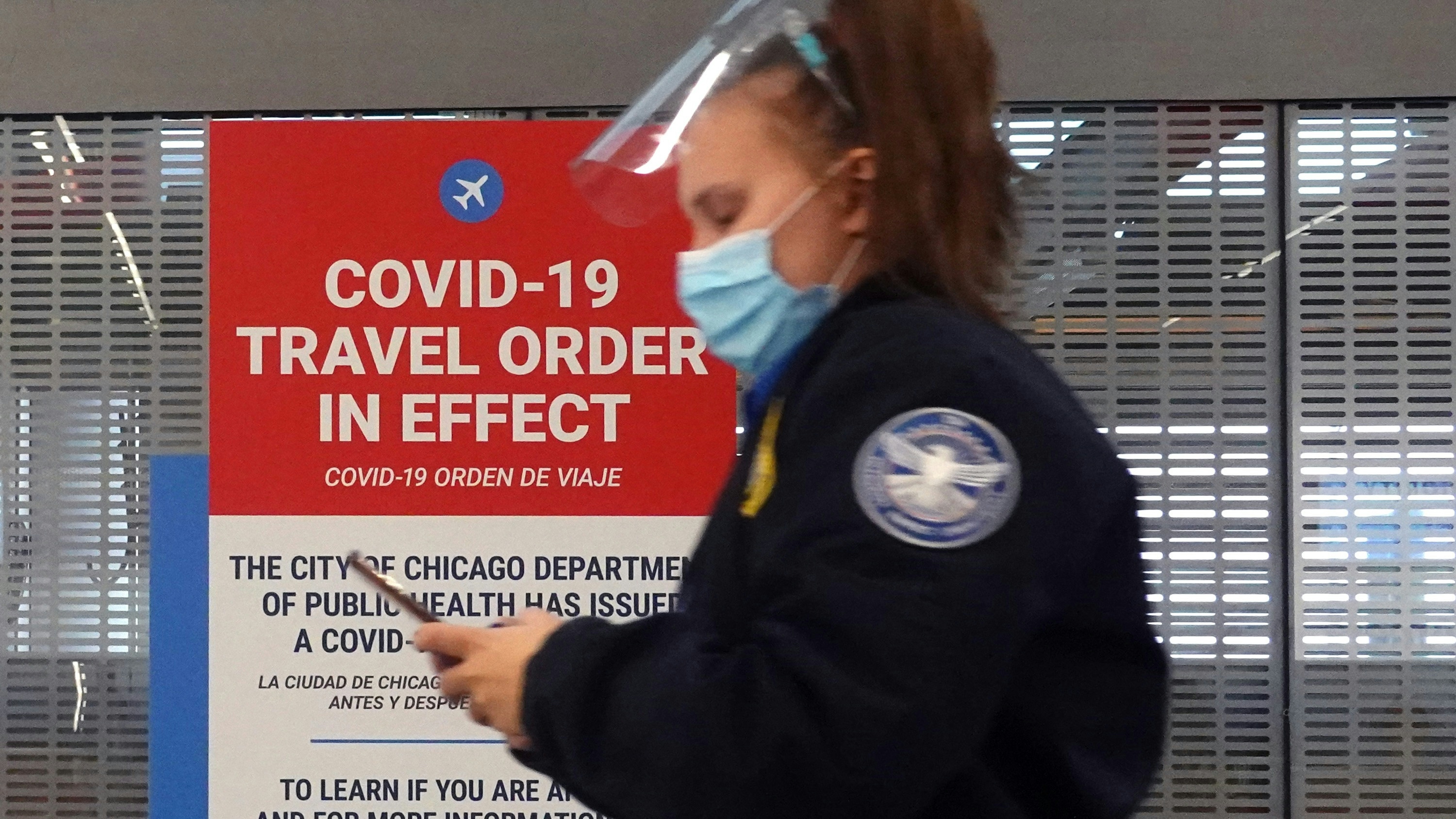 A warning for travelers flying during the pandemic is posted at O'Hare International Airport on November 24, 2020 in Chicago, Illinois.
