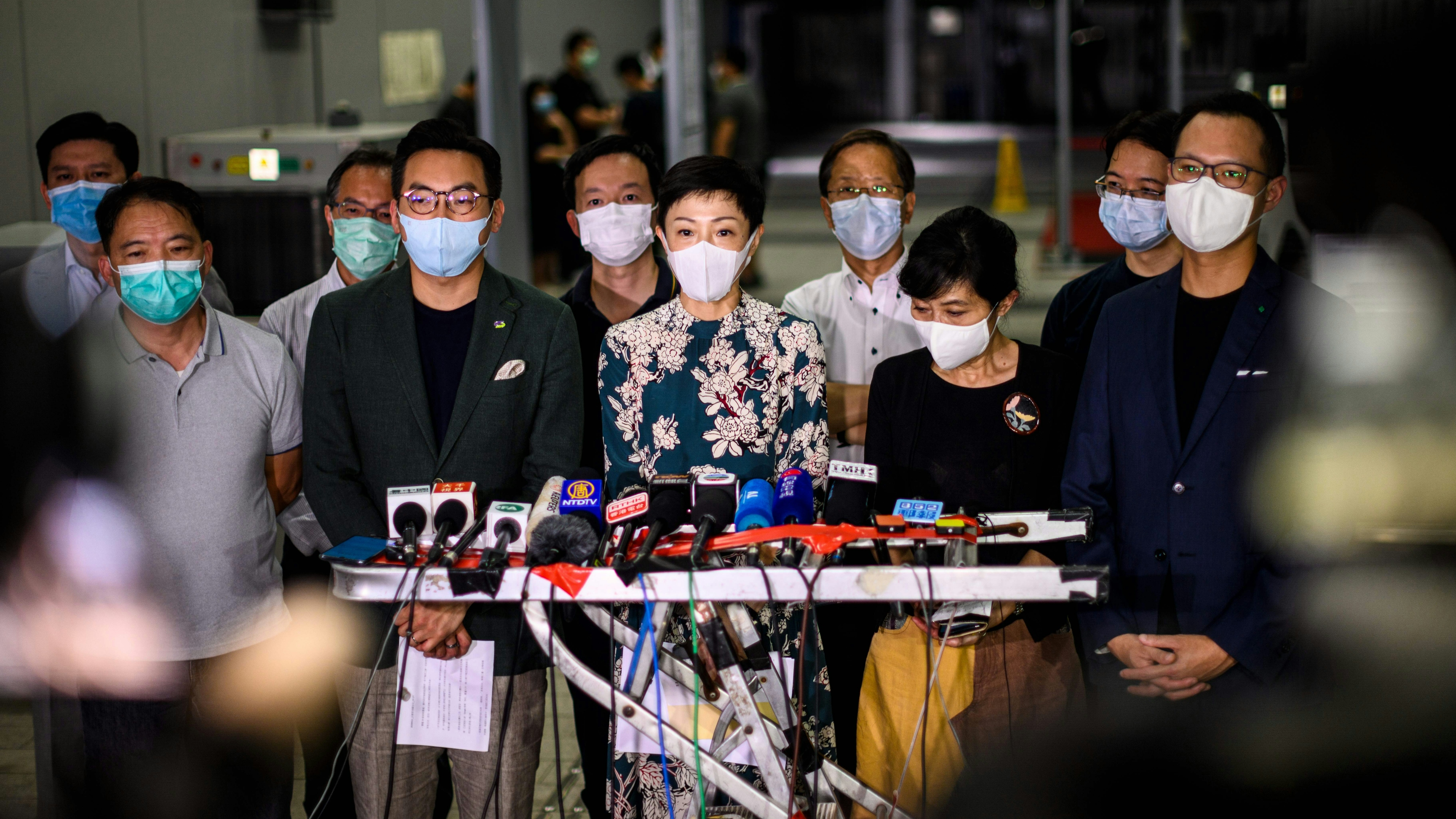 Pro-democracy lawmakers gather outside the entrance of the Hong Kong Legislative Council for a press conference.