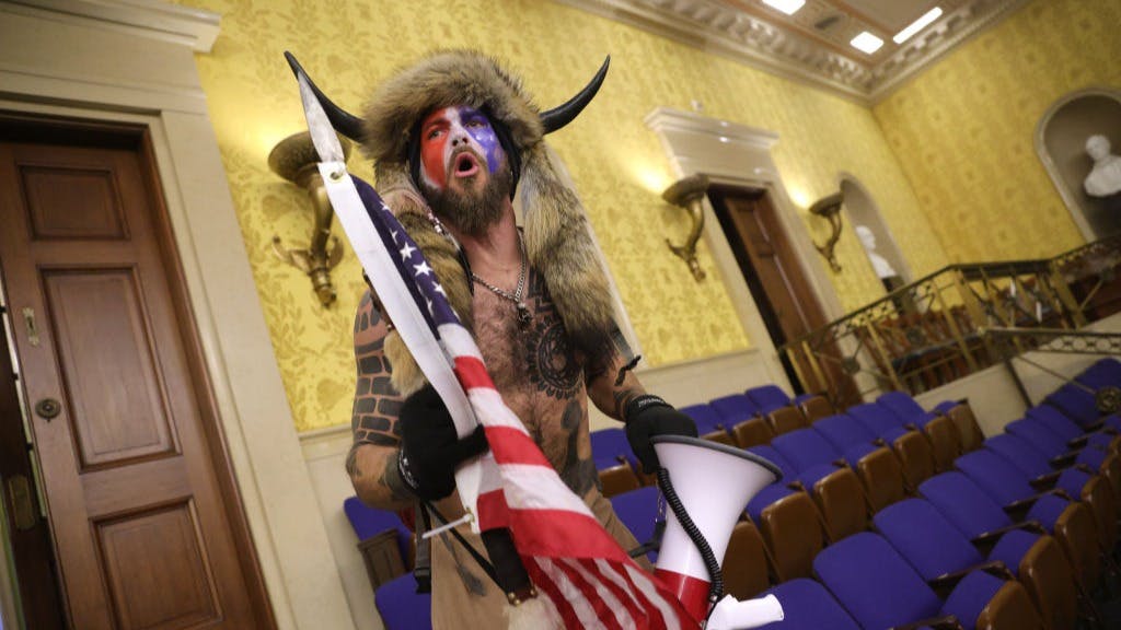 Jacob Chansley inside the Senate chamber after the U.S. Capitol was breached by a pro-Trump mob on January 06, 2021.