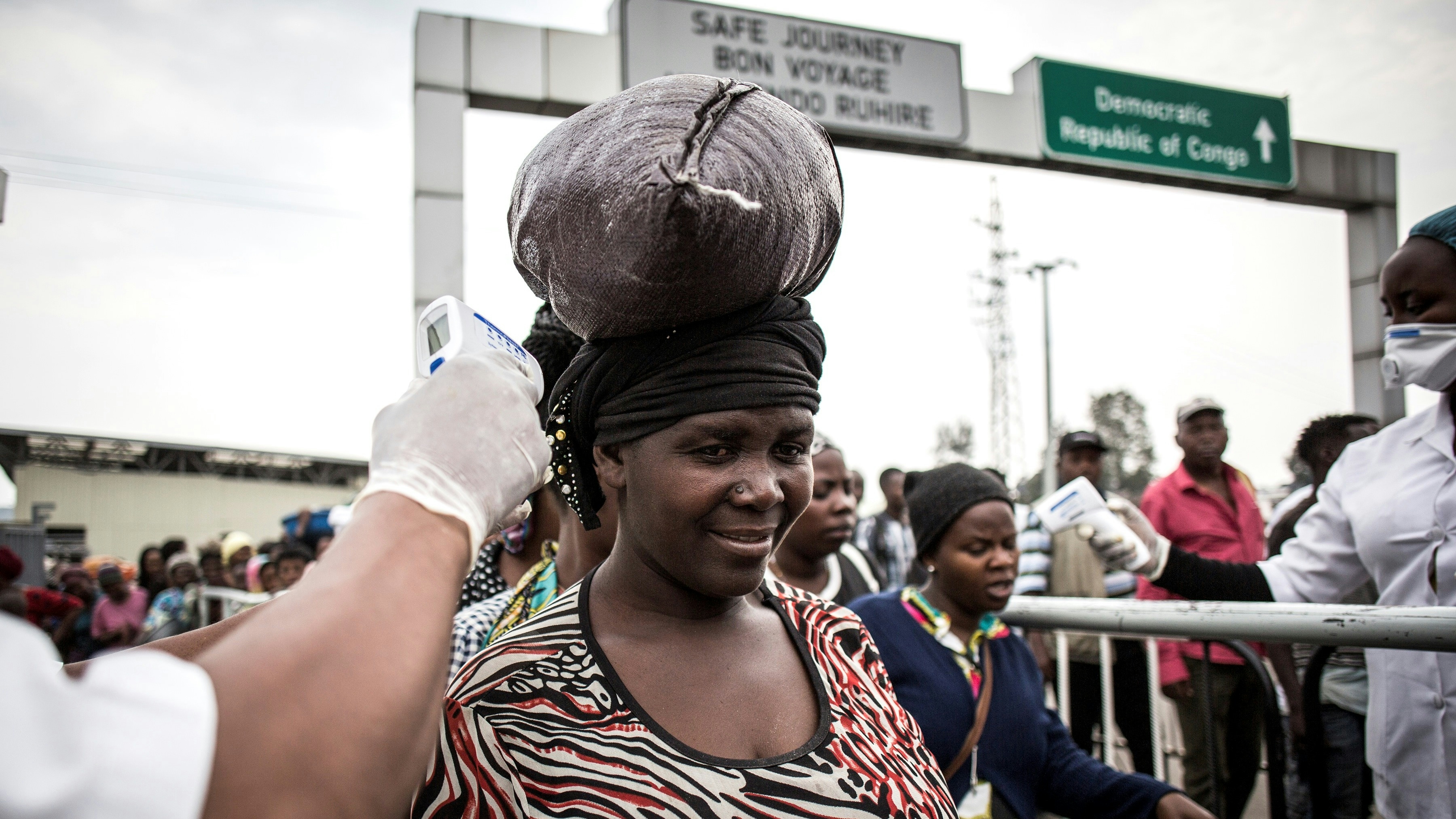 Women getting a temp check for Ebola
