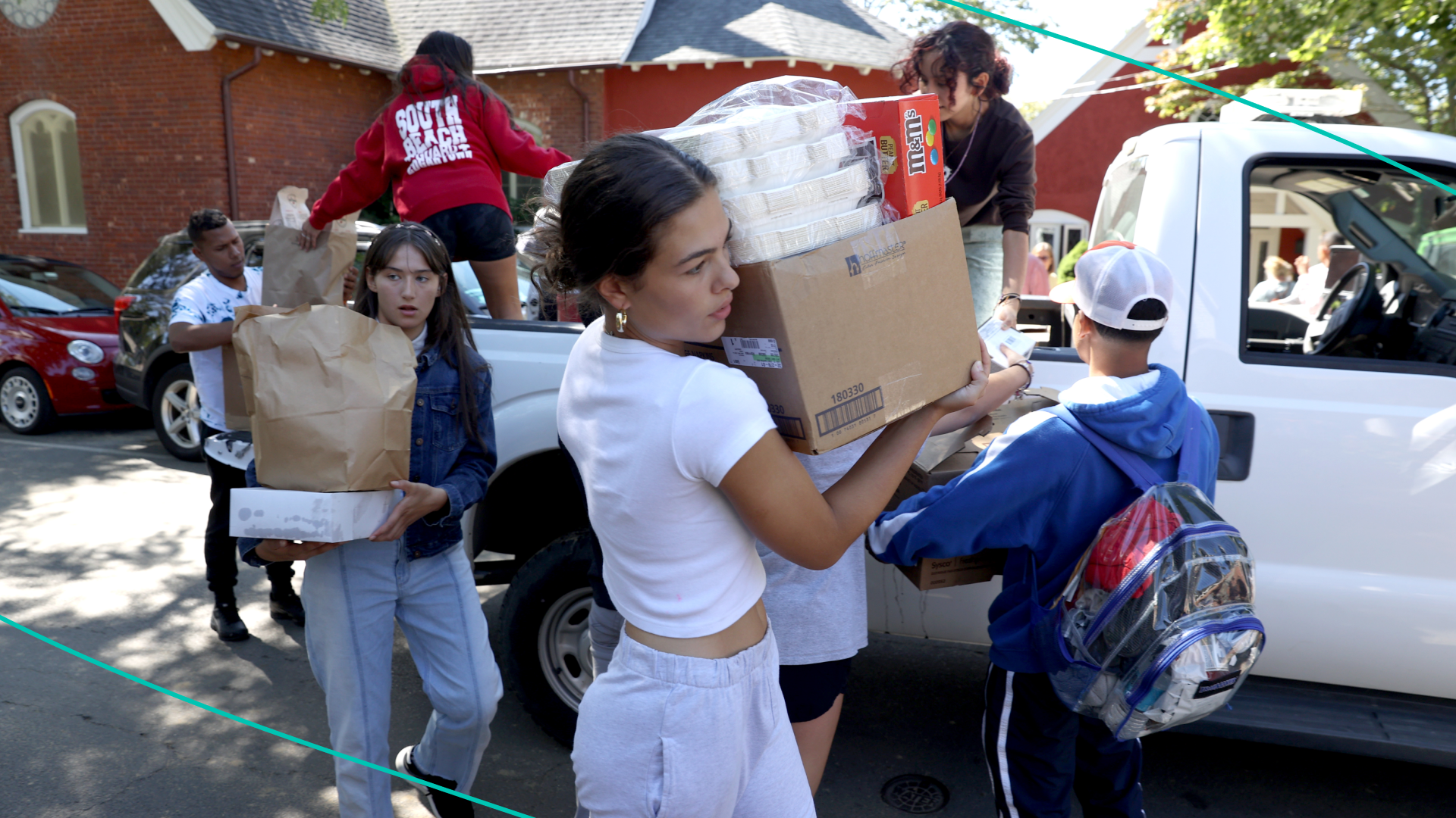 People unload supplies from a truck