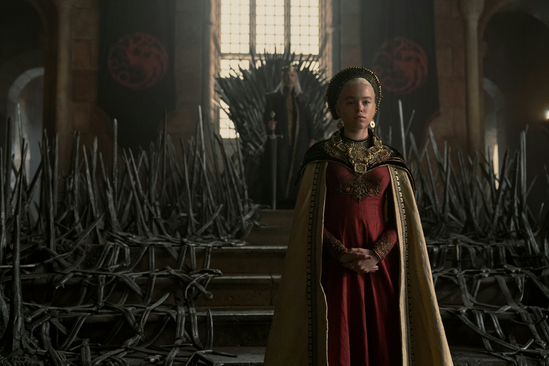 Princess Rhaenyra standing in front of her father, King Viserys Targaryen