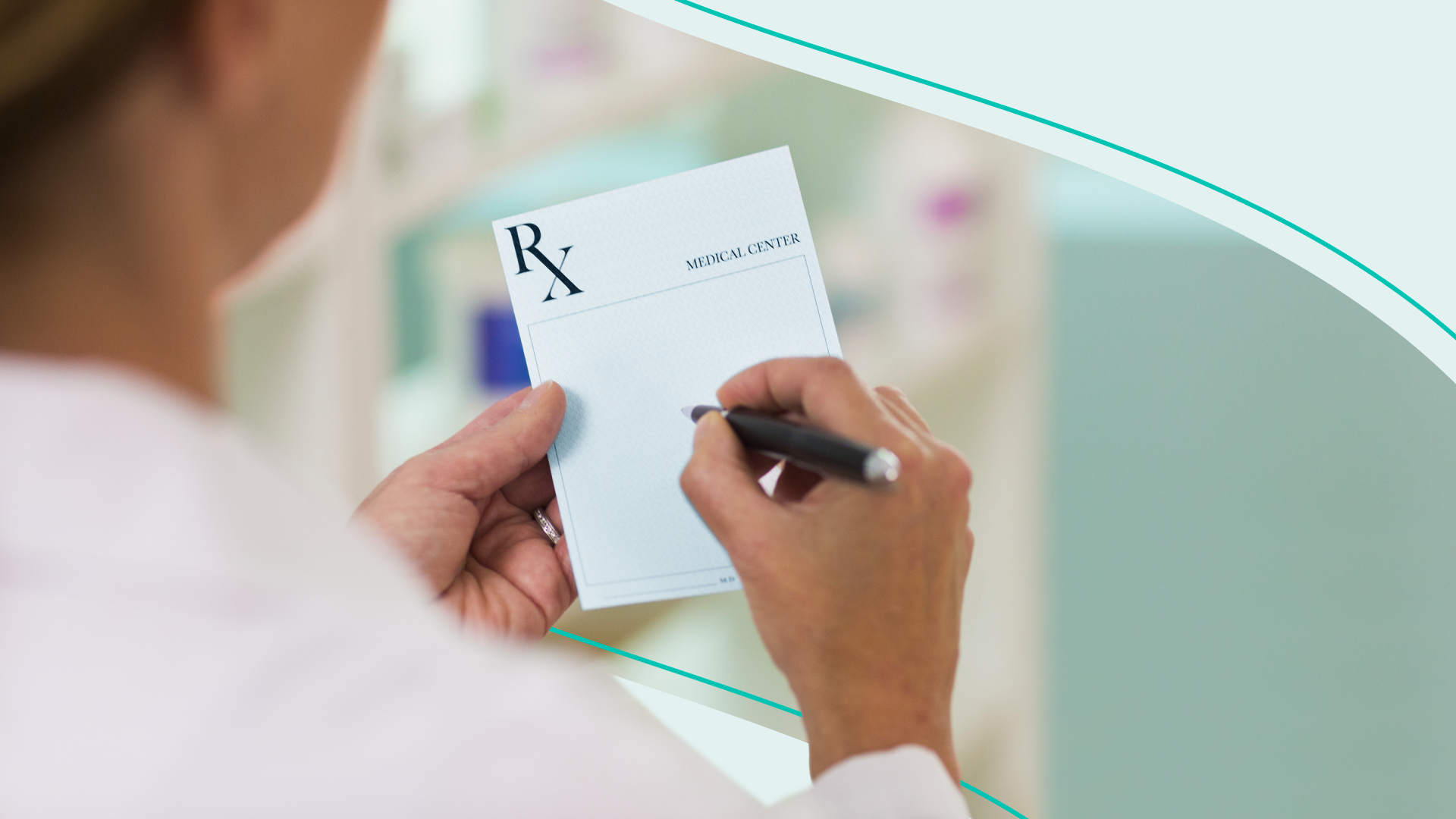 A physician holds a blank prescription pad 
