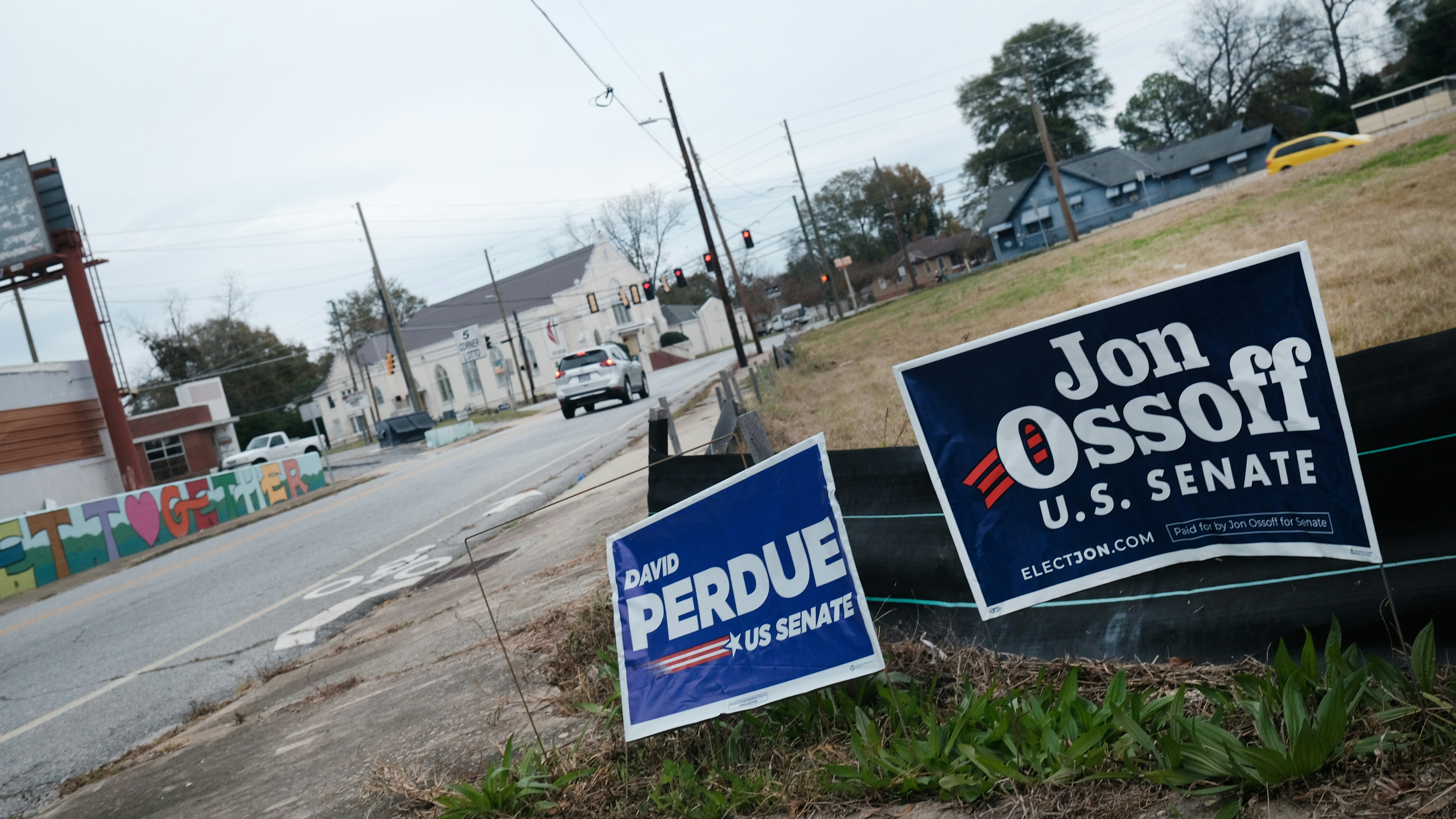Signs for senate candidates David Perdue (R-GA) and Sen. Kelly Loeffler (R-GA) stand in a yard on December 06, 2020 in Columbus, Georgia.