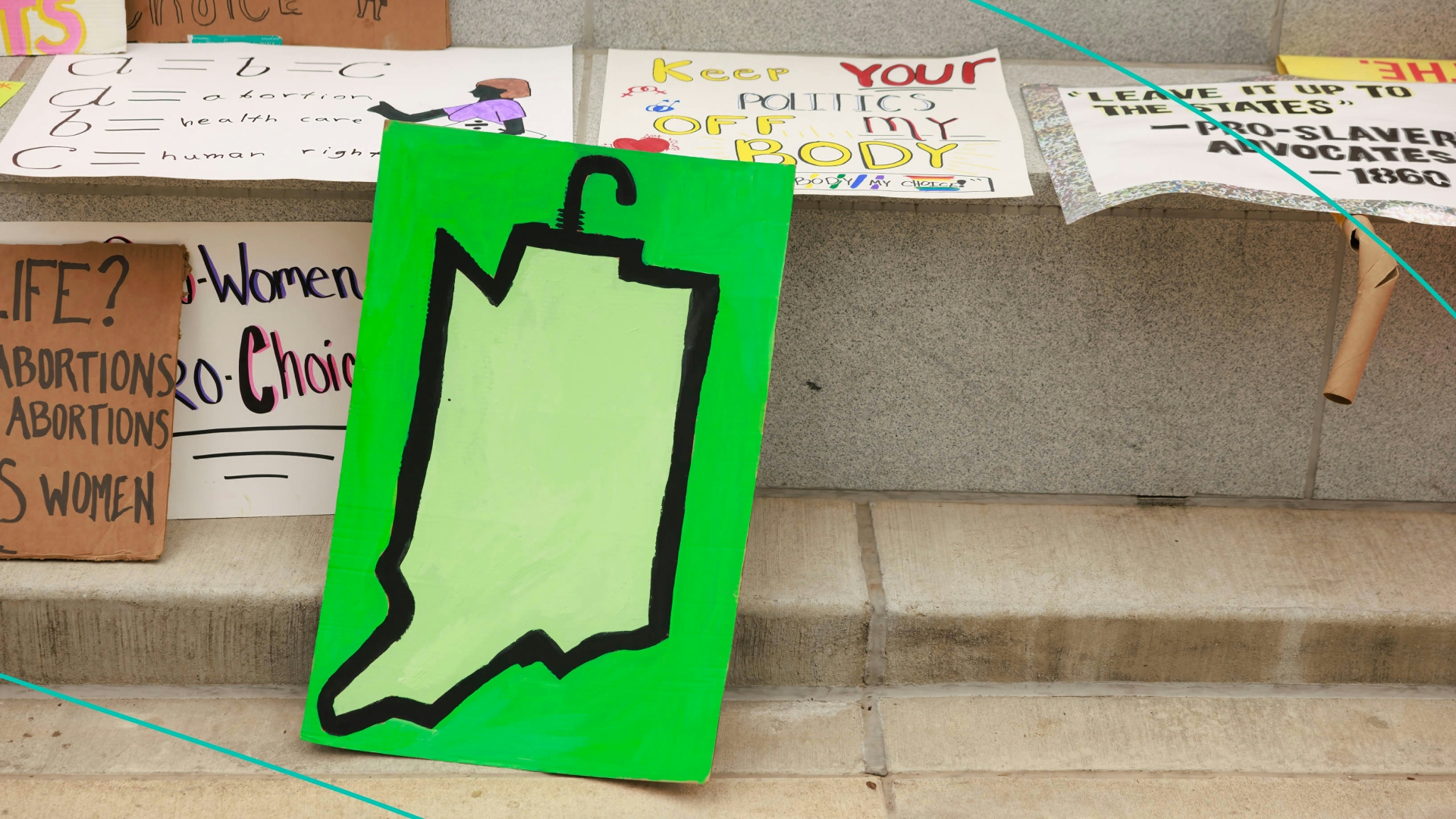 Abortion-rights protesters leave a drawing of the state of Indiana during the demonstration.