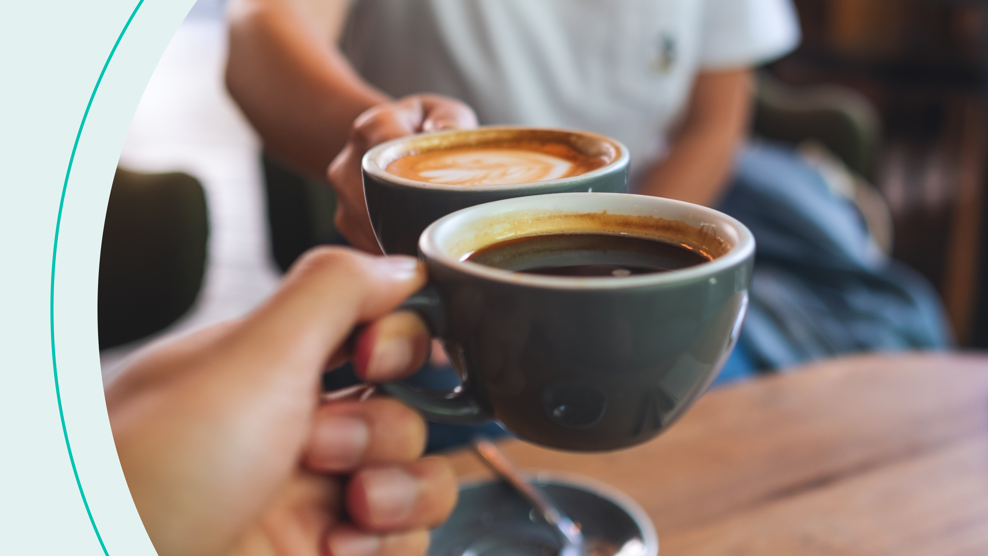 Two people clinking coffee mugs 