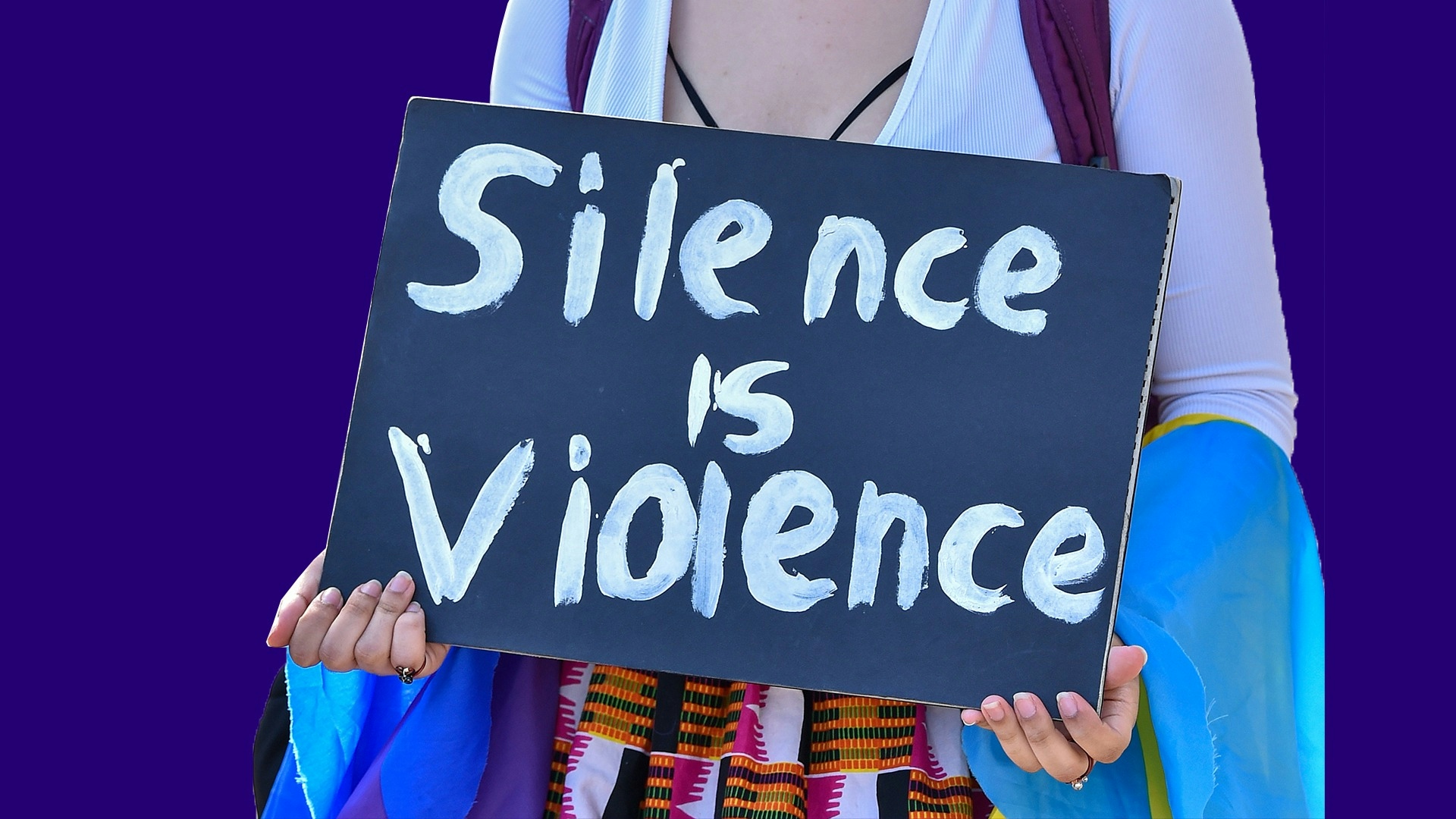 Protester holding silence is violence sign