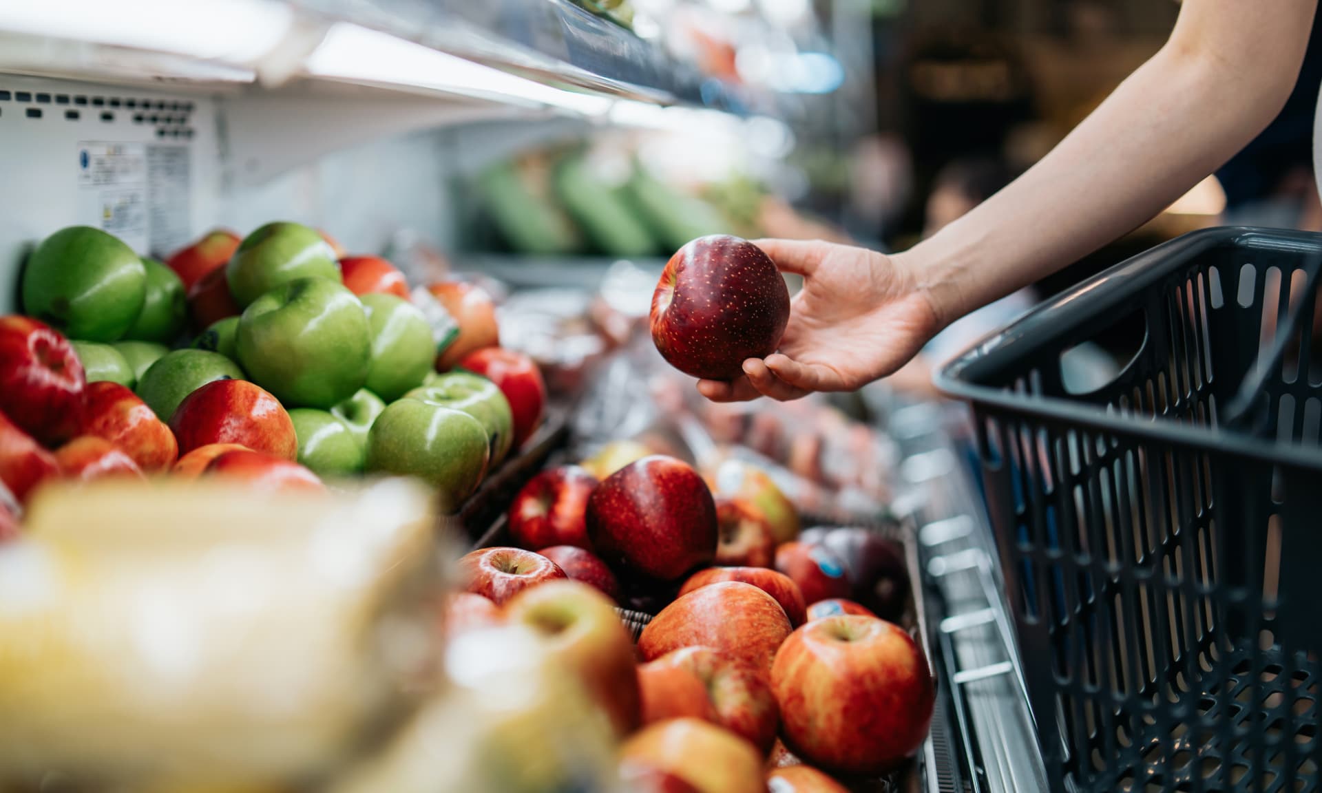 Someone buying apples at the grocery store