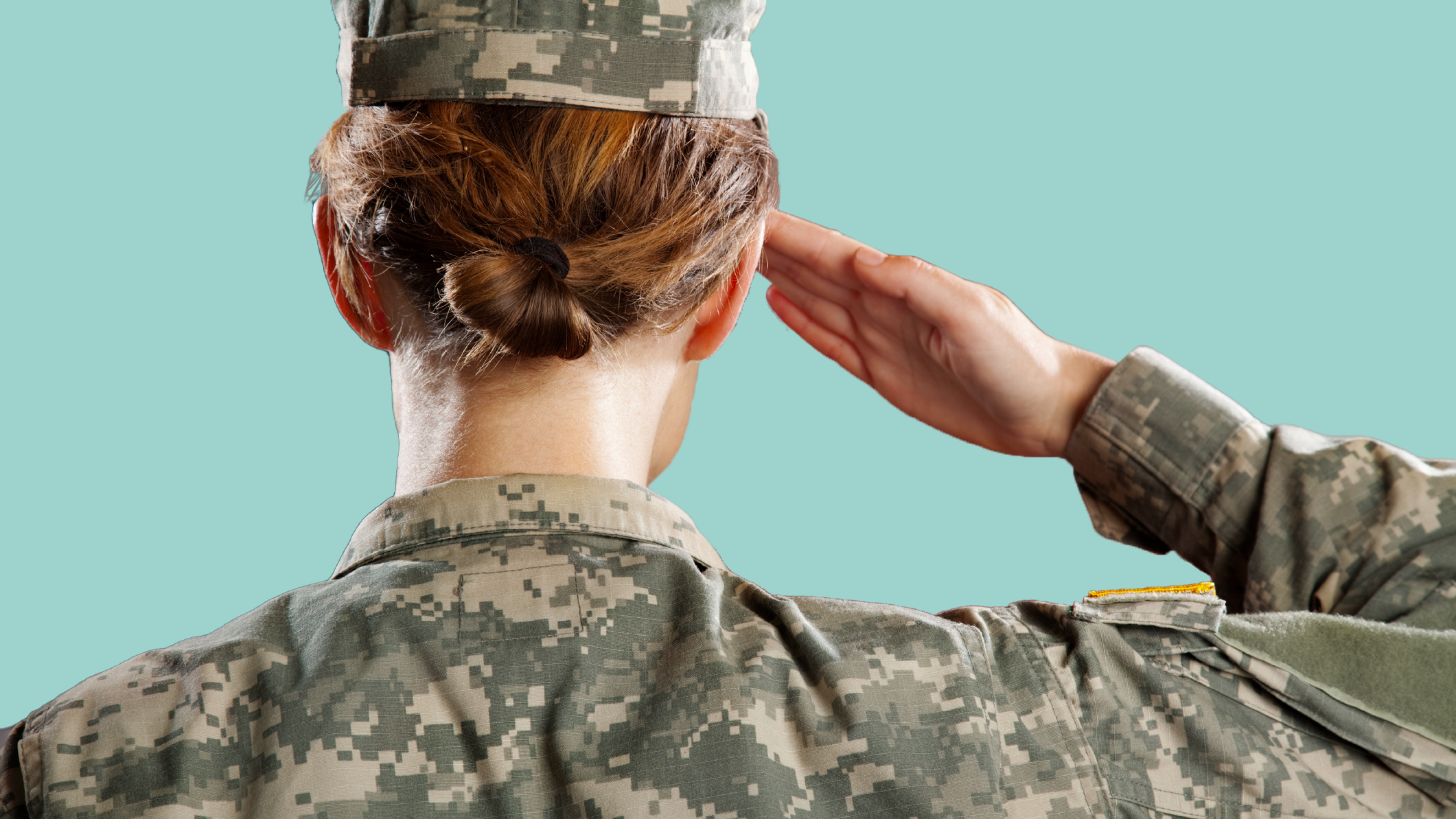 A woman wearing a US armed forces uniform standing in salute