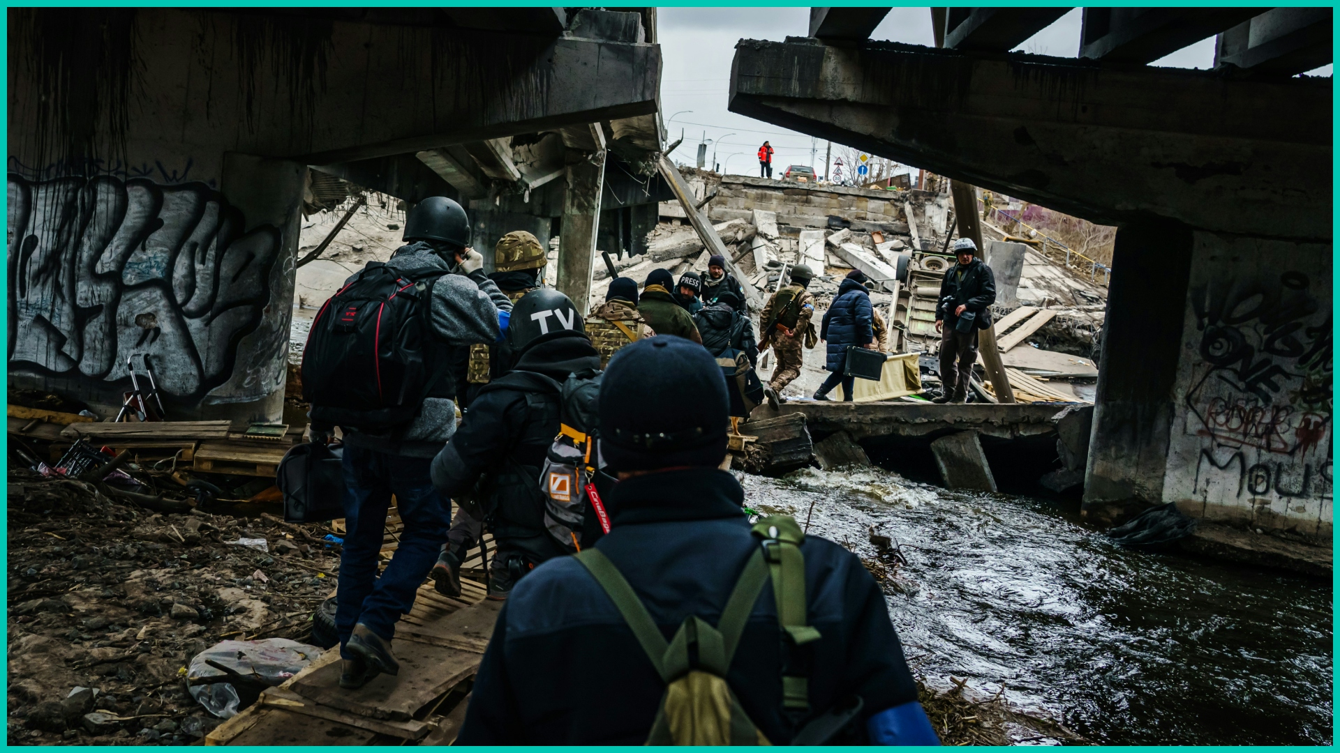 People walking by wreckage in Ukraine