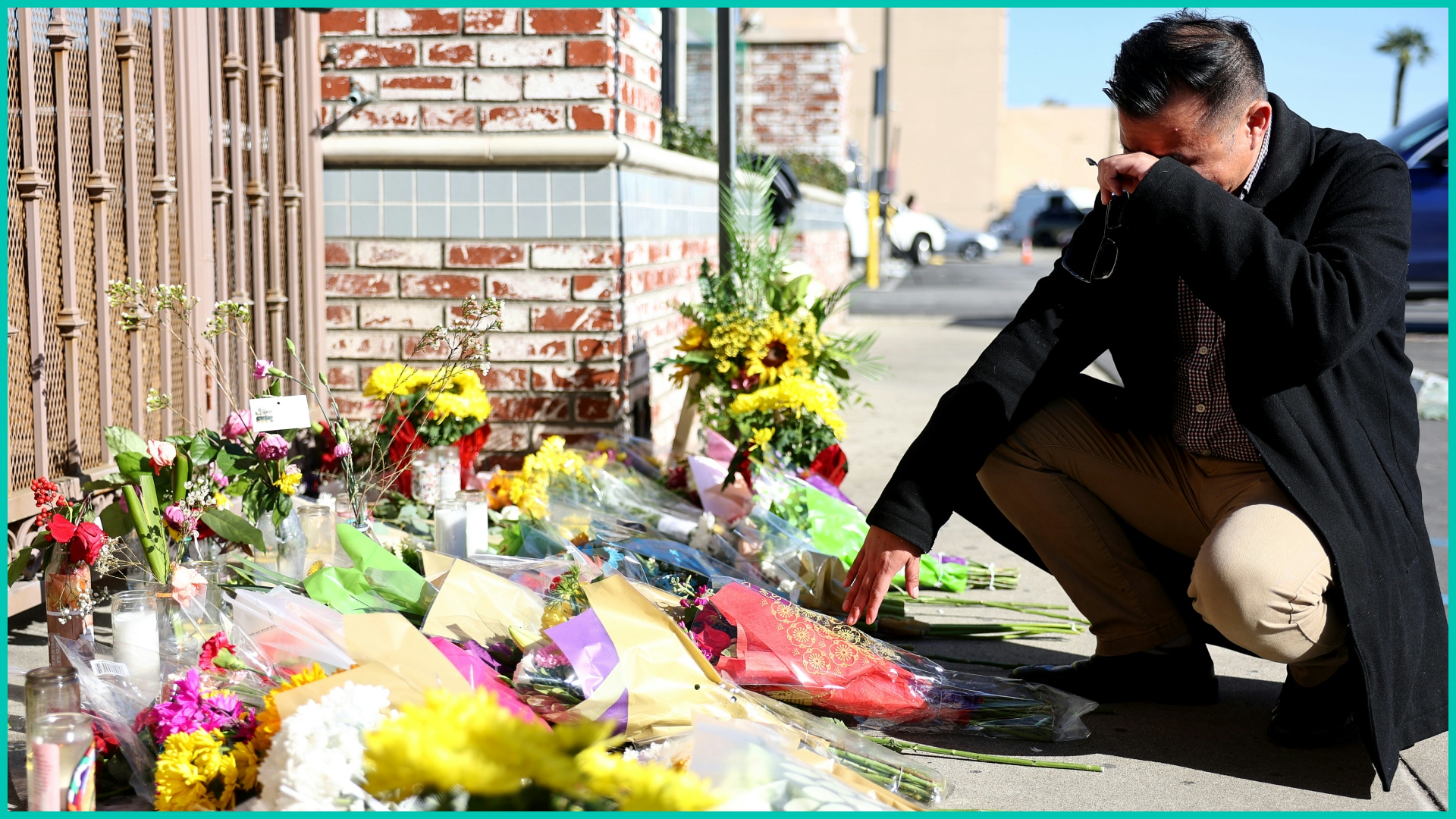 Monterey Park mayor Henry Lo kneels at a makeshift memorial outside the scene of a deadly mass shooting at a ballroom dance studio on January 23, 202