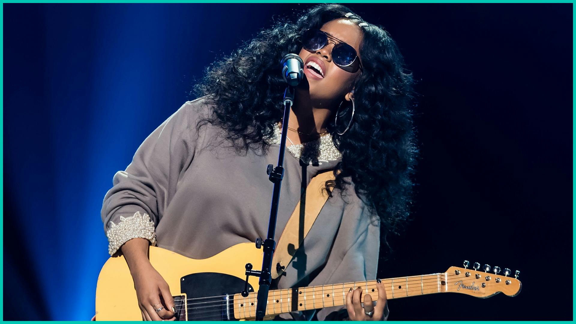 H.E.R. performing at concert