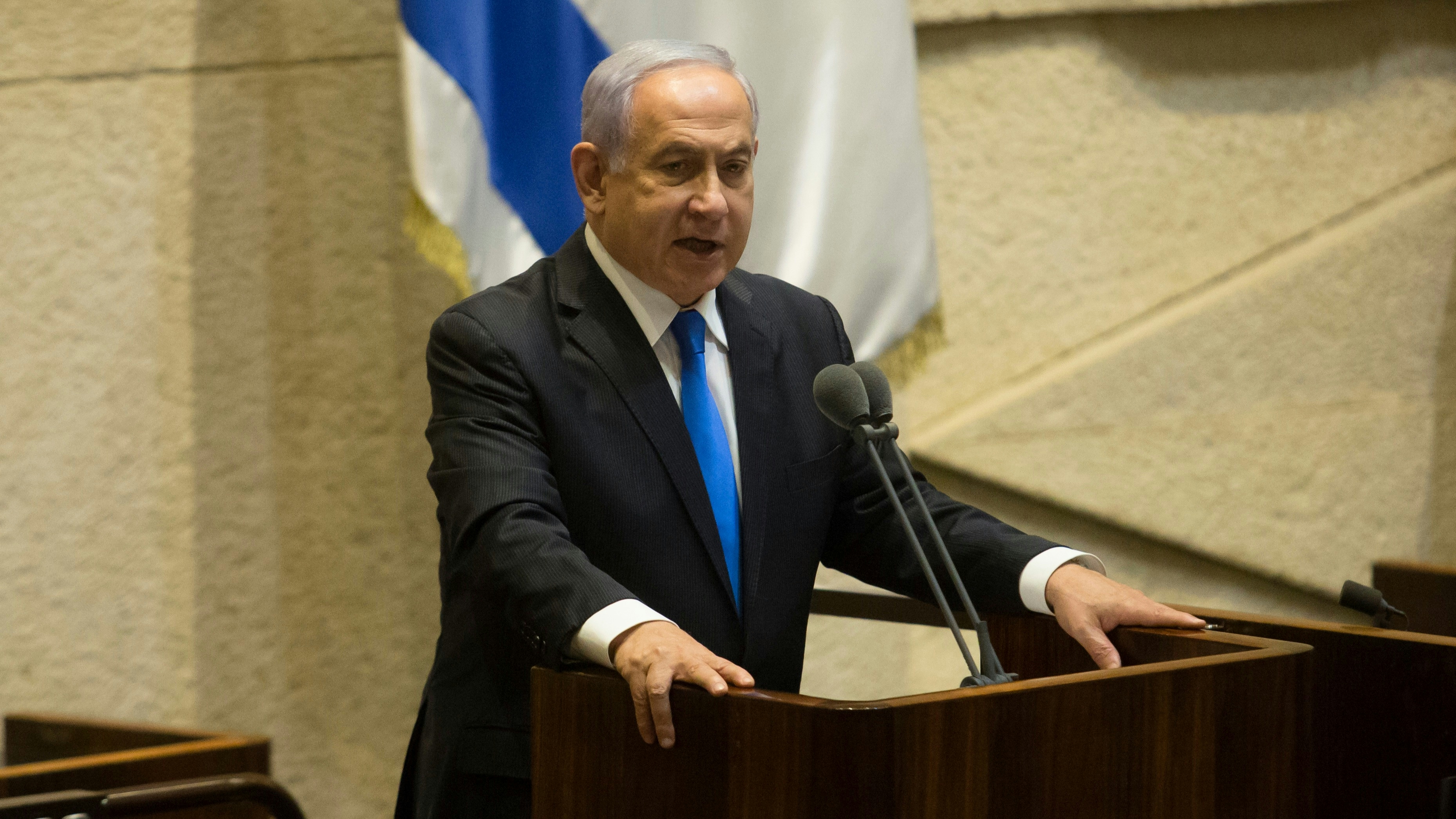 Israeli Prime Minister Benjamin Netanyahu speaks before parliament votes to approve the new government.