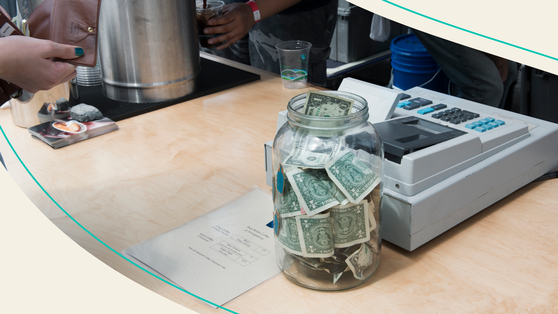 A tip jar on a restaurant counter.