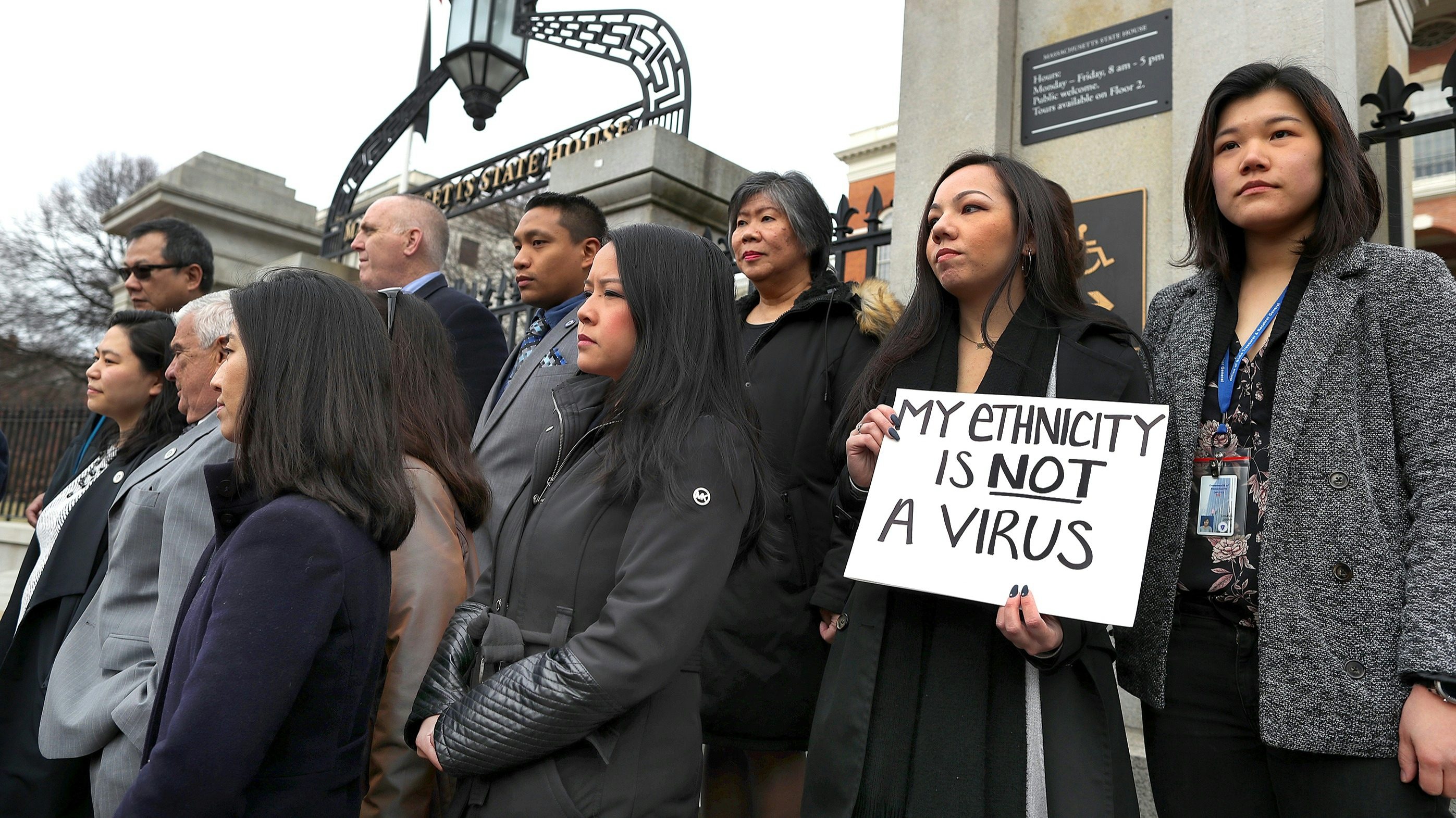 Members of the Asian American Commission hold a press conference on the steps of the Massachusetts State House to condemn racism towards the Asian American community.