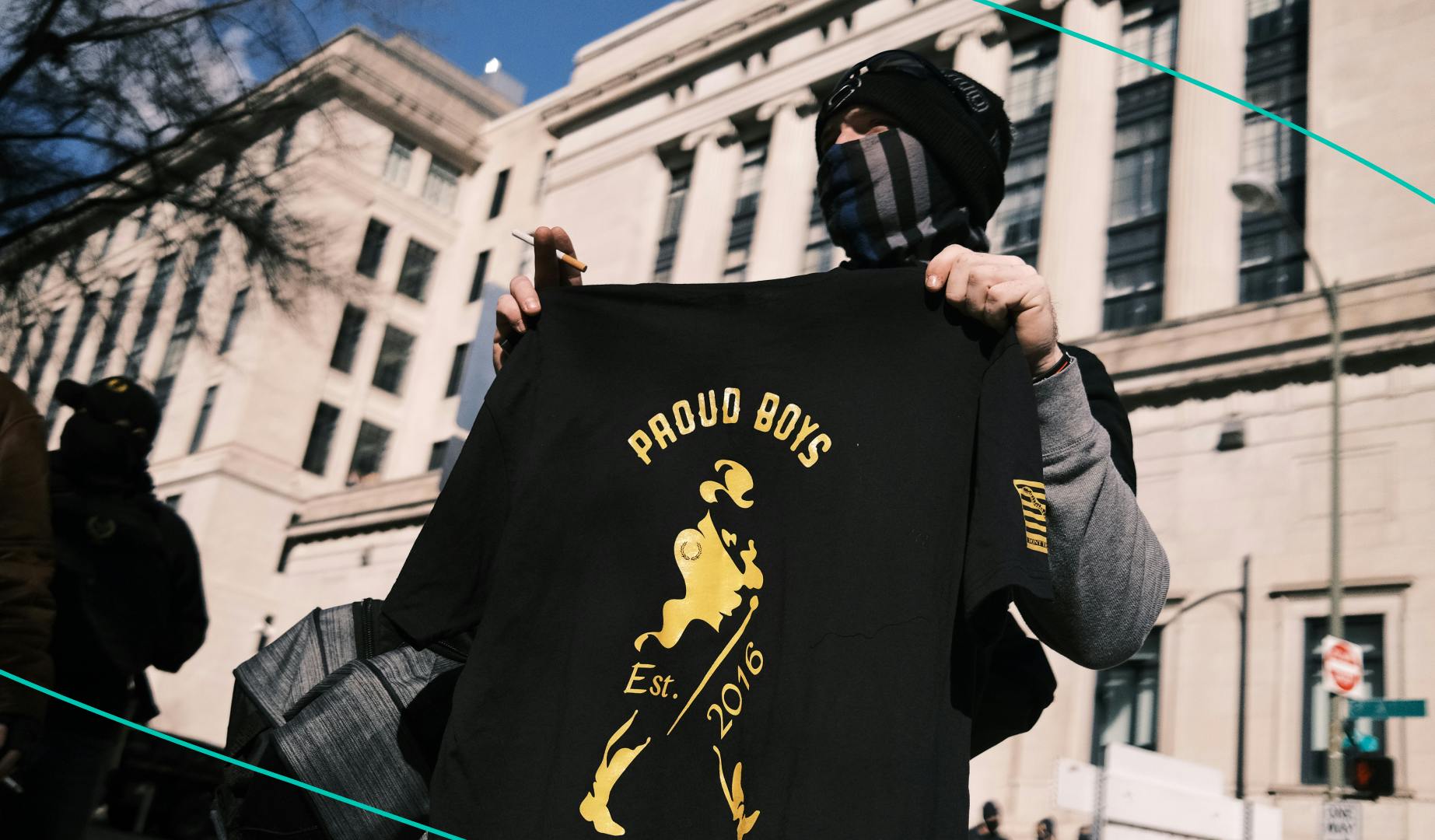 A member of the Proud Boys holds up a t-shirt 