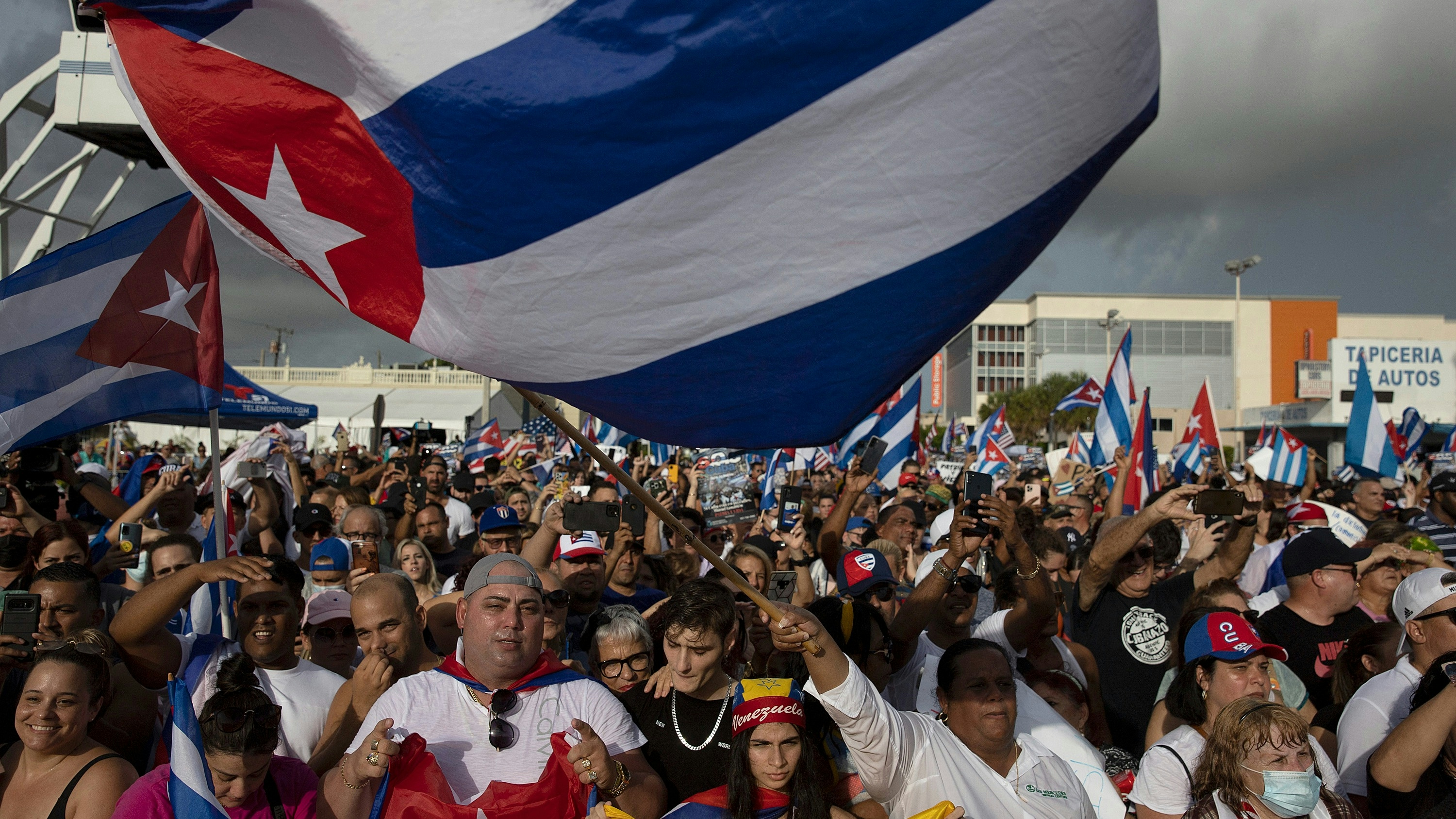 Protesters gather in front of the Versailles restaurant in the Little Havana neighborhood to show their support for the people in Cuba that have taken to the streets to protest.