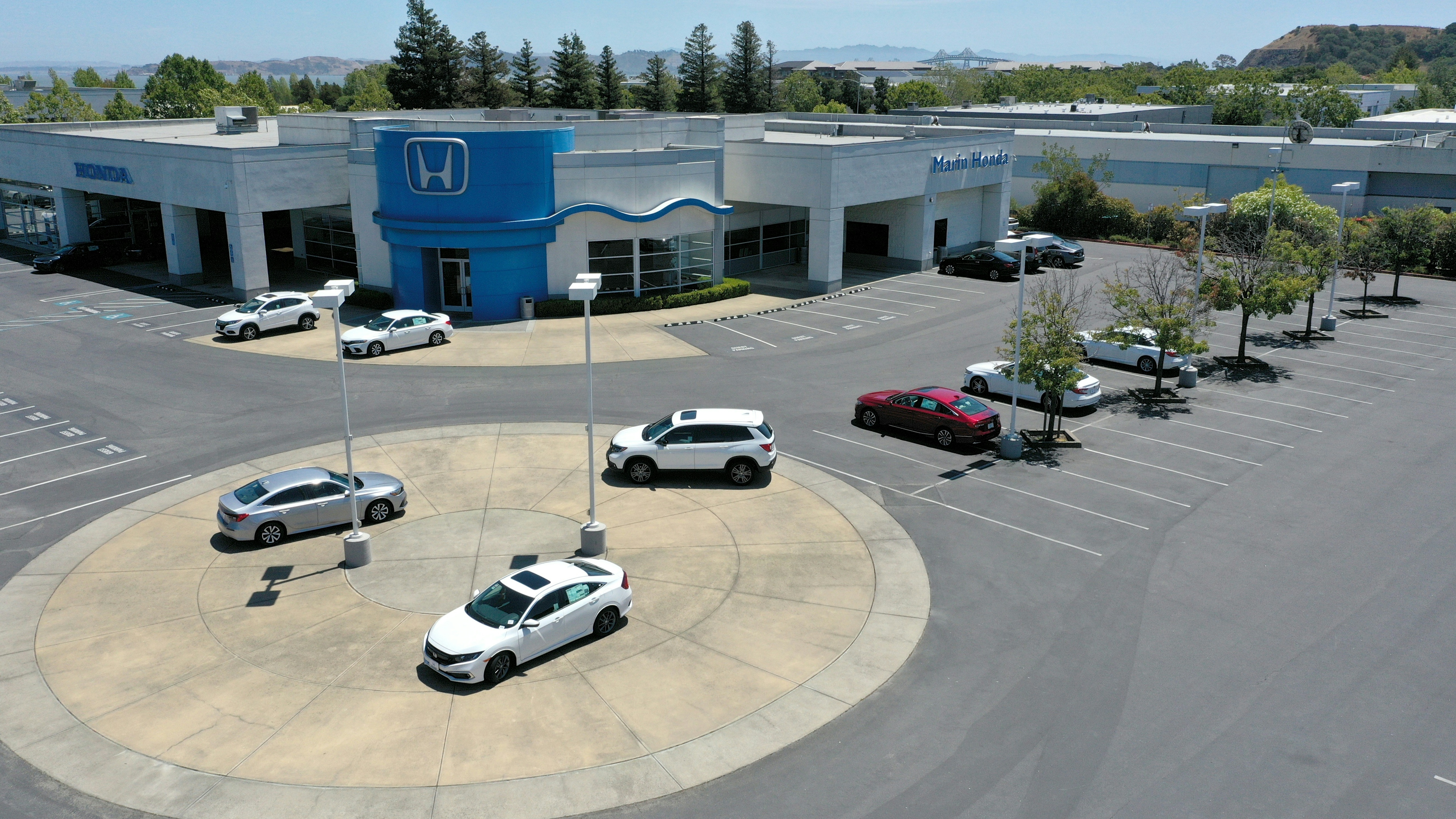 In an aerial view, the sales lot at Marin Honda is nearly empty