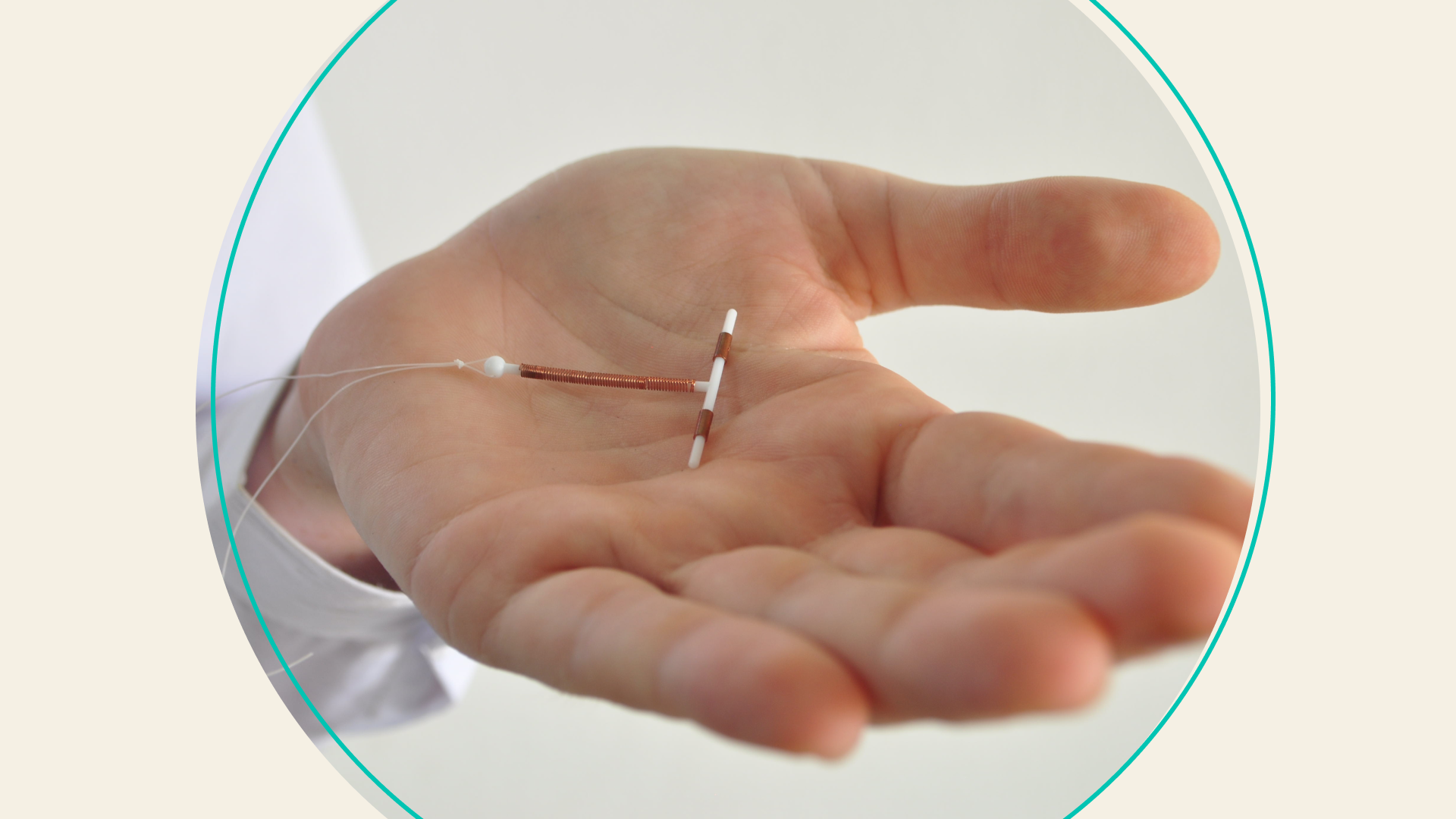 A doctor holding a copper IUD in their palm